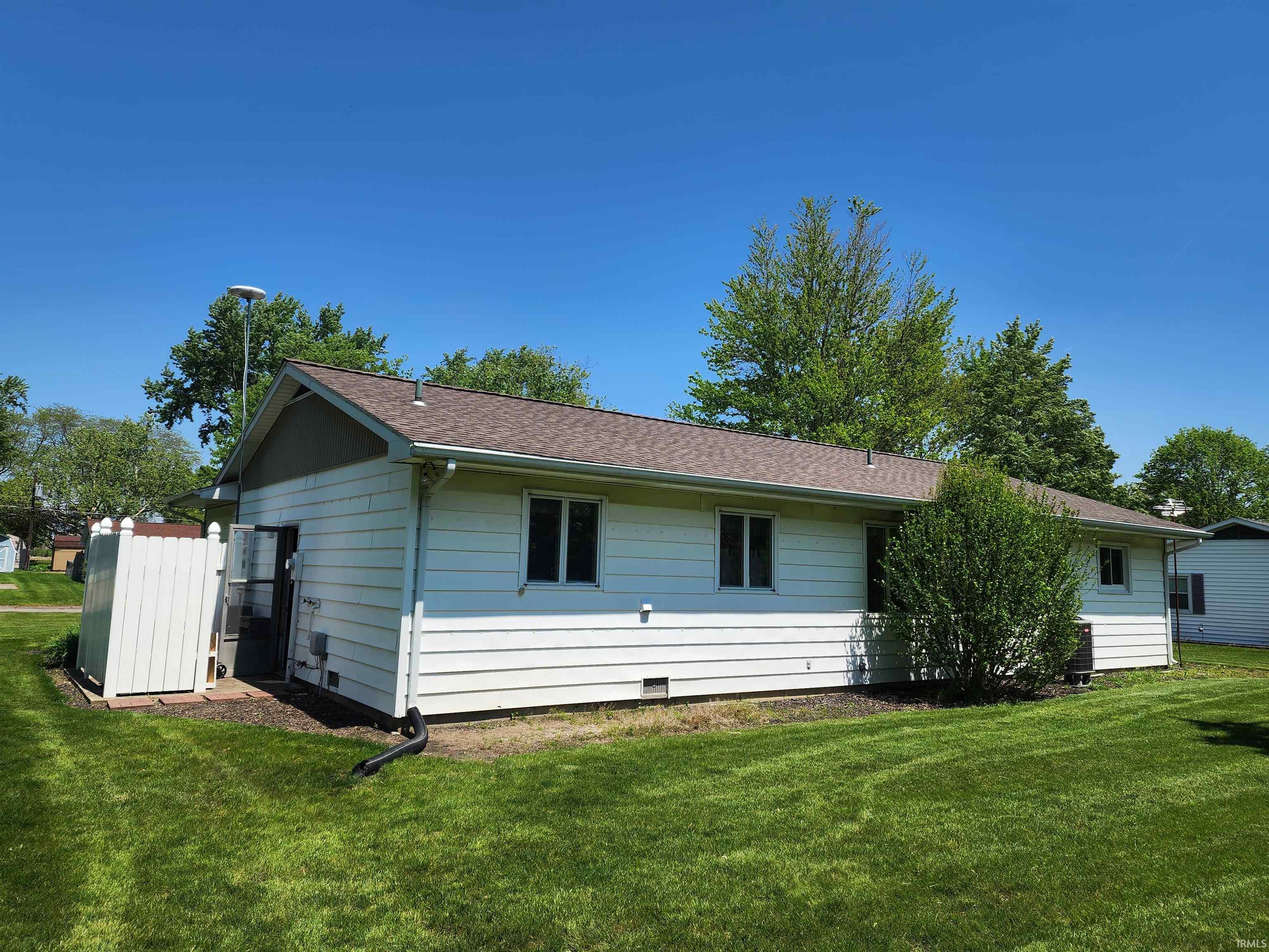 White horizontal siding exterior with a brown shingle roof
