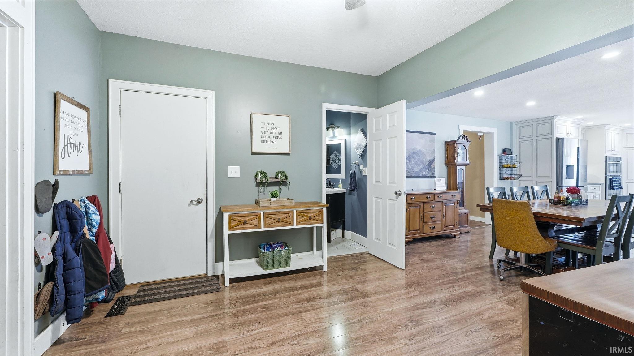 Wood-finish flooring extending into an open-concept dining area