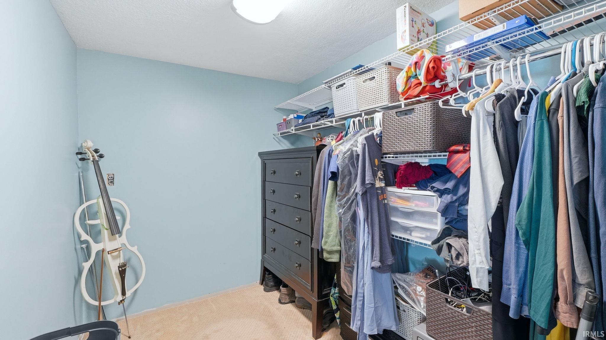 Custom closet system featuring wire shelving and hanging rods