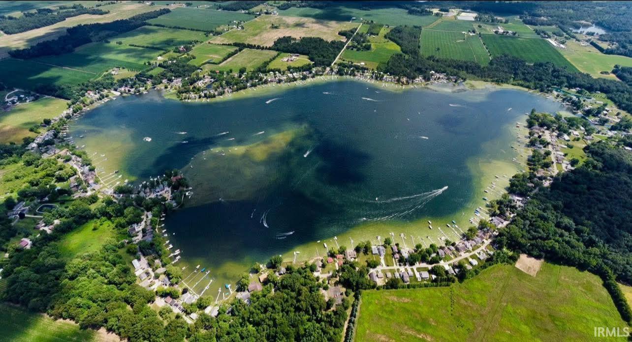 Expansive lake surrounded by residential properties and green landscapes