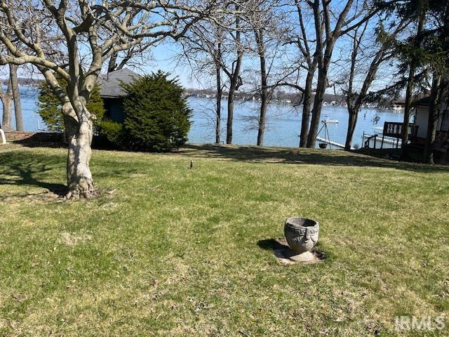 View of grassy yard with a water view