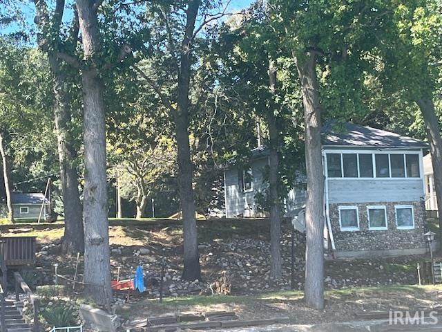 View of side of home with a sunroom