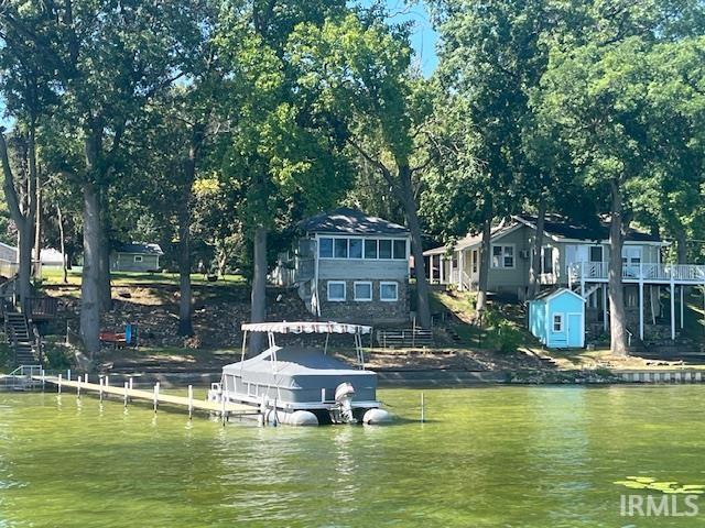 Dock featuring a water view and stairs