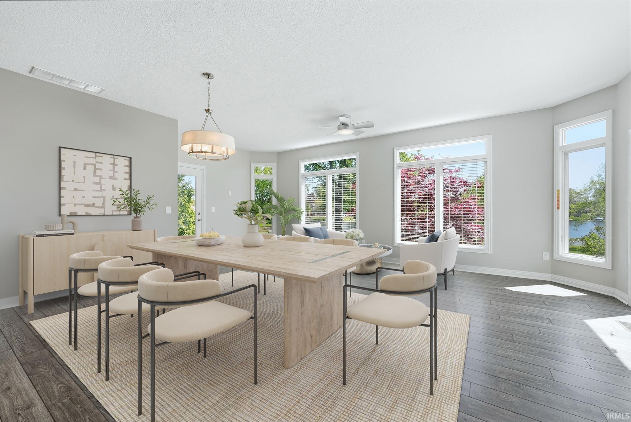 Bright dining area featuring wood-finish flooring, a contemporary chandelier, and large windows