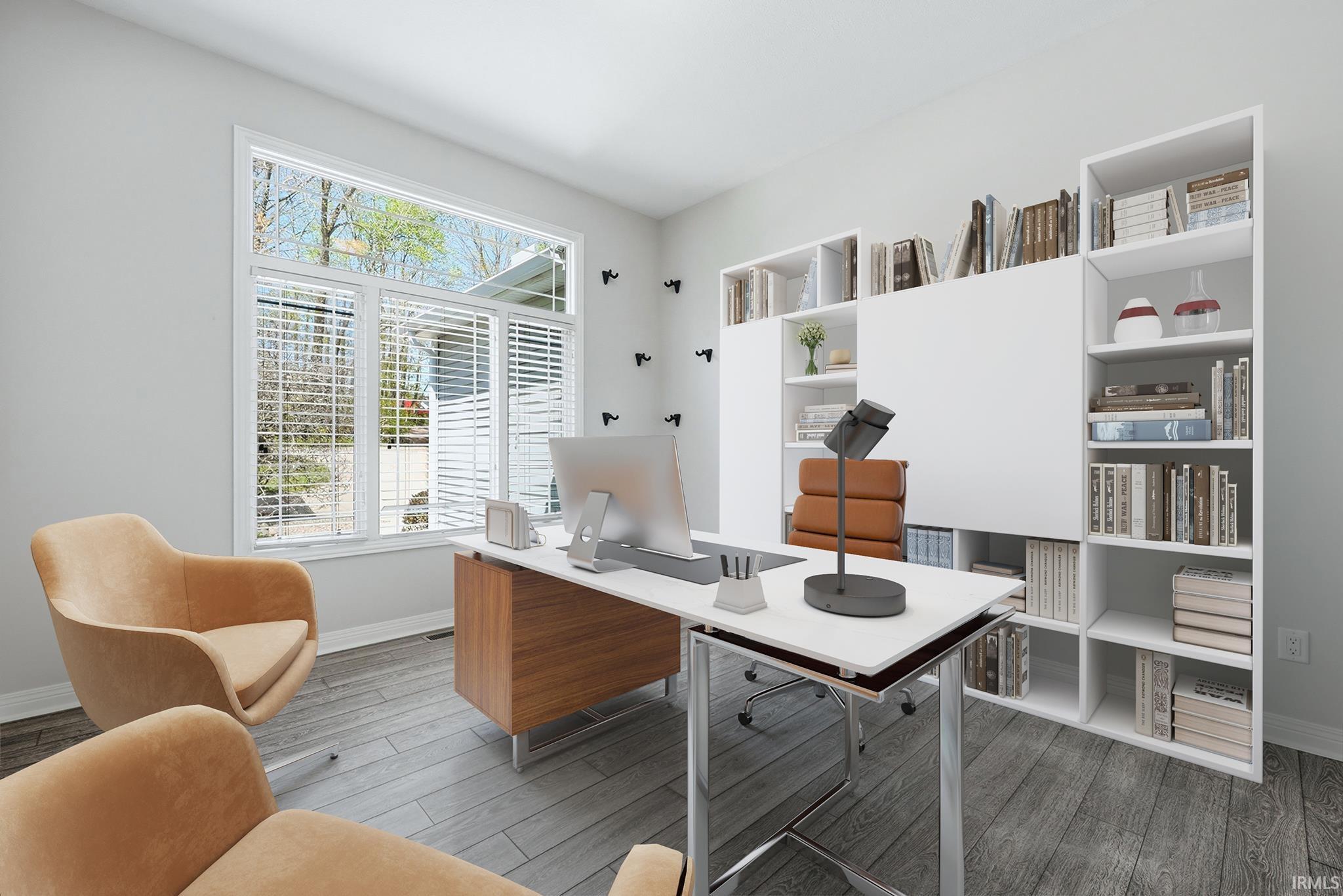 Bright room featuring wood-finish flooring, a large multi-pane window, and a built-in white shelving system with integrated closed storage