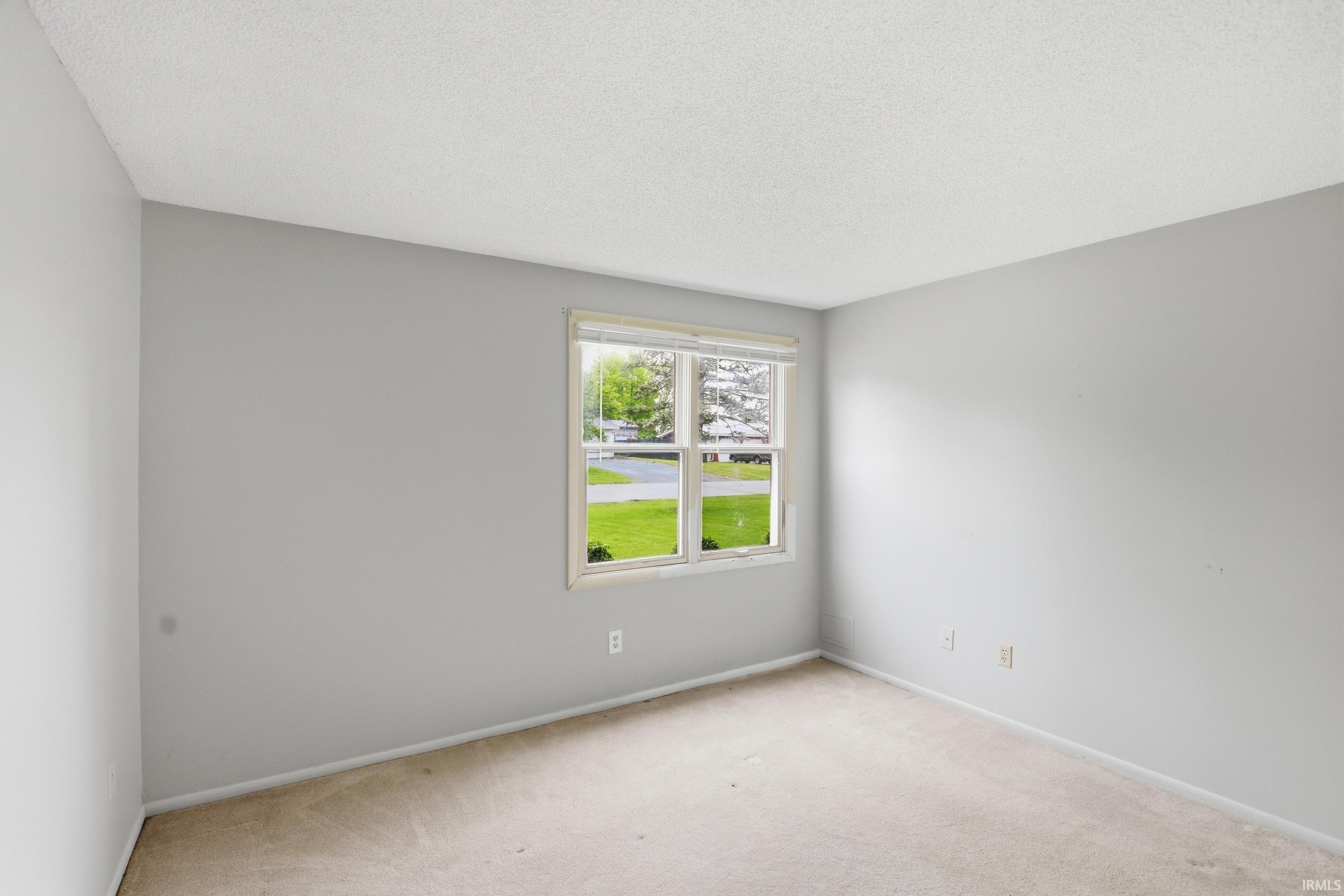 Room featuring light gray painted walls and carpeted flooring