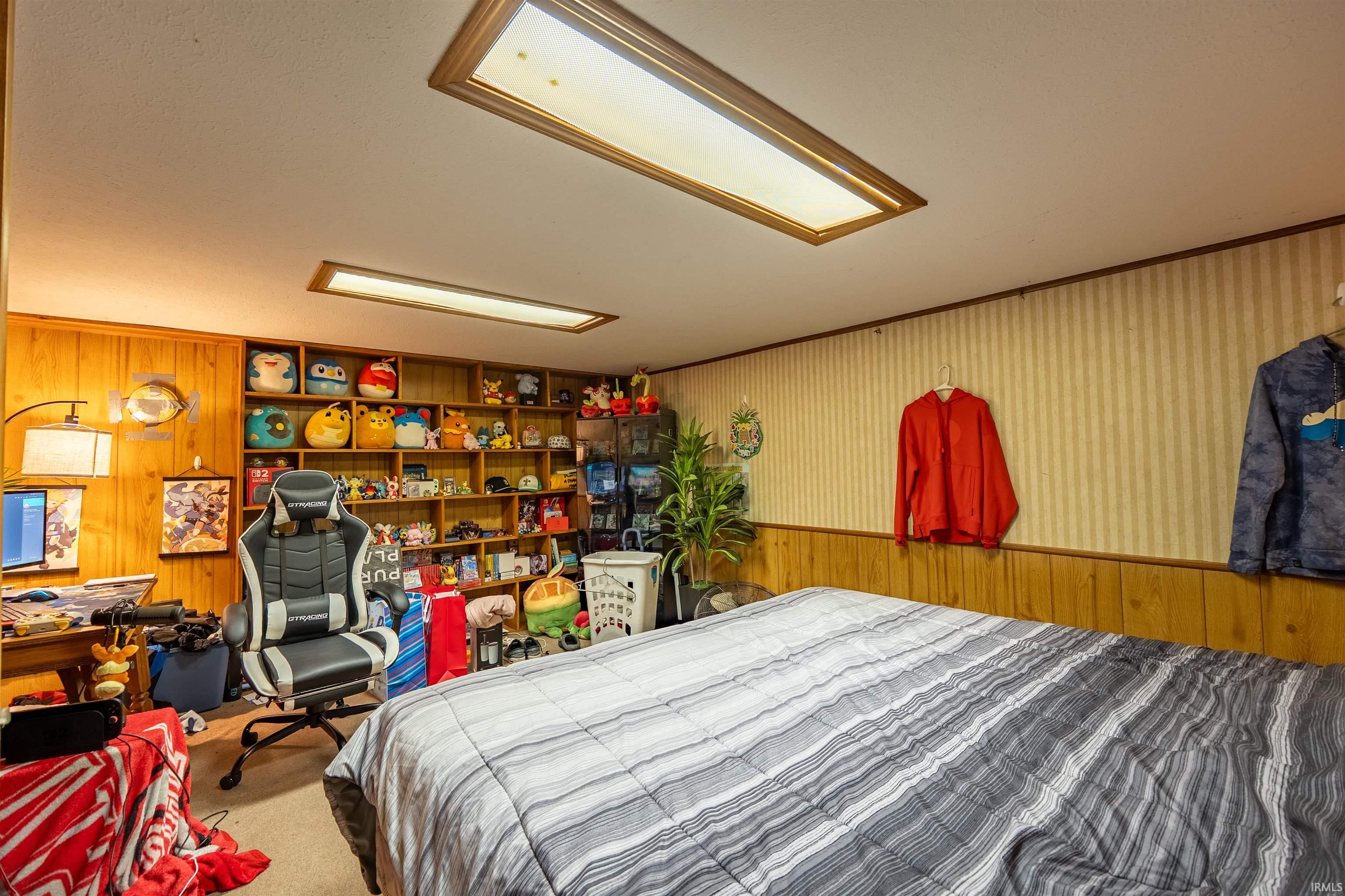 Room with wood paneling and striped wallpaper