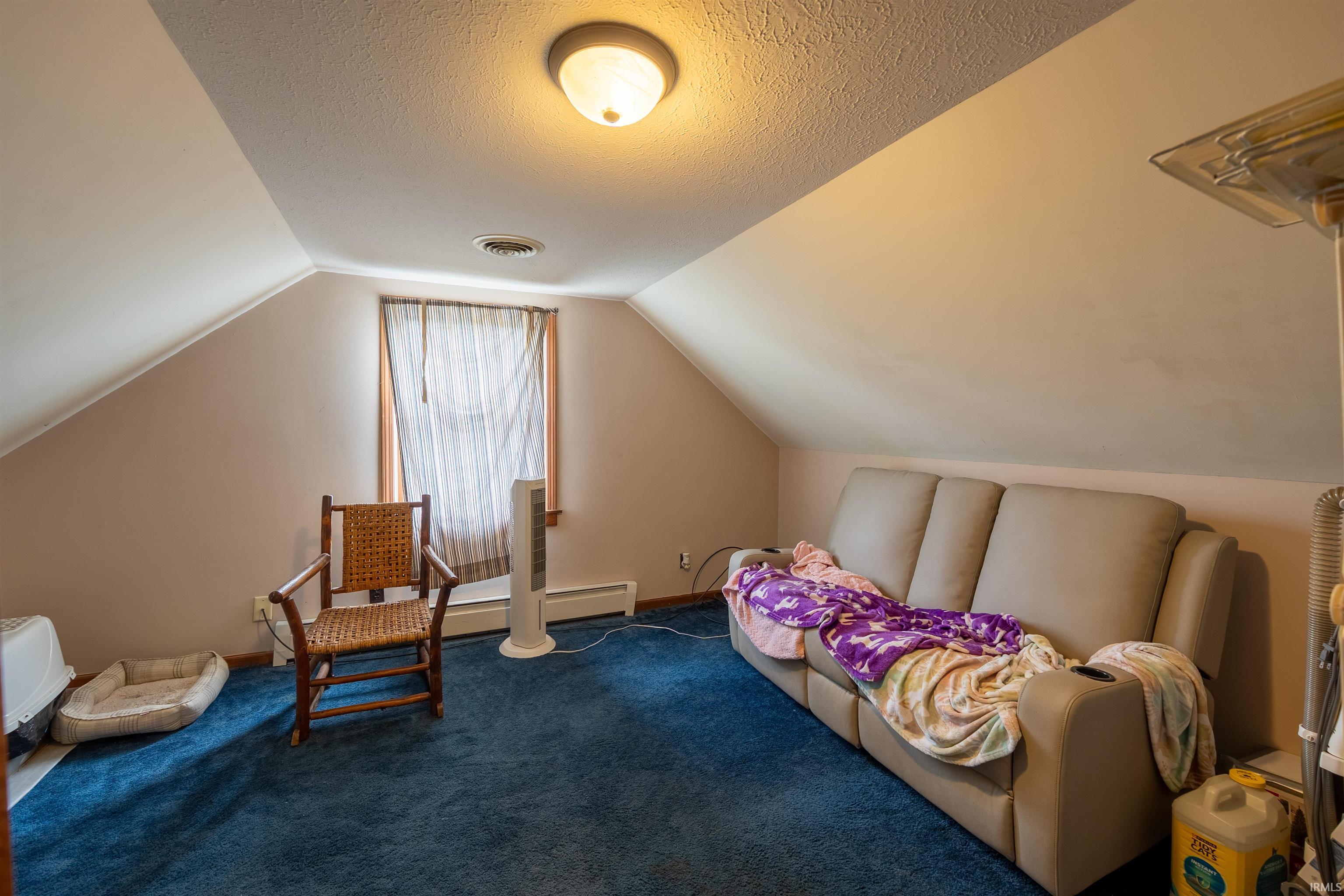 Sloped ceilings and a window with wood trim