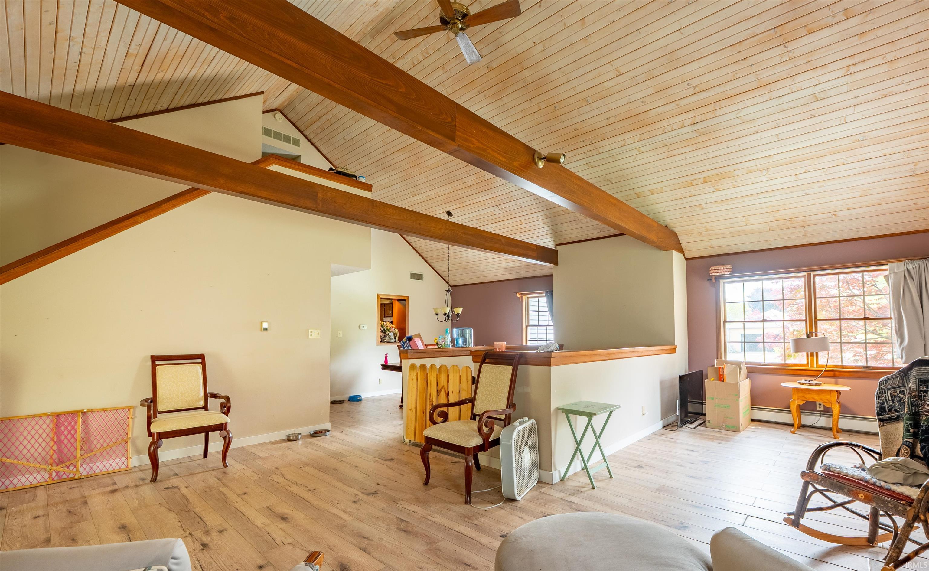Vaulted ceiling with exposed wood beams and beadboard finish