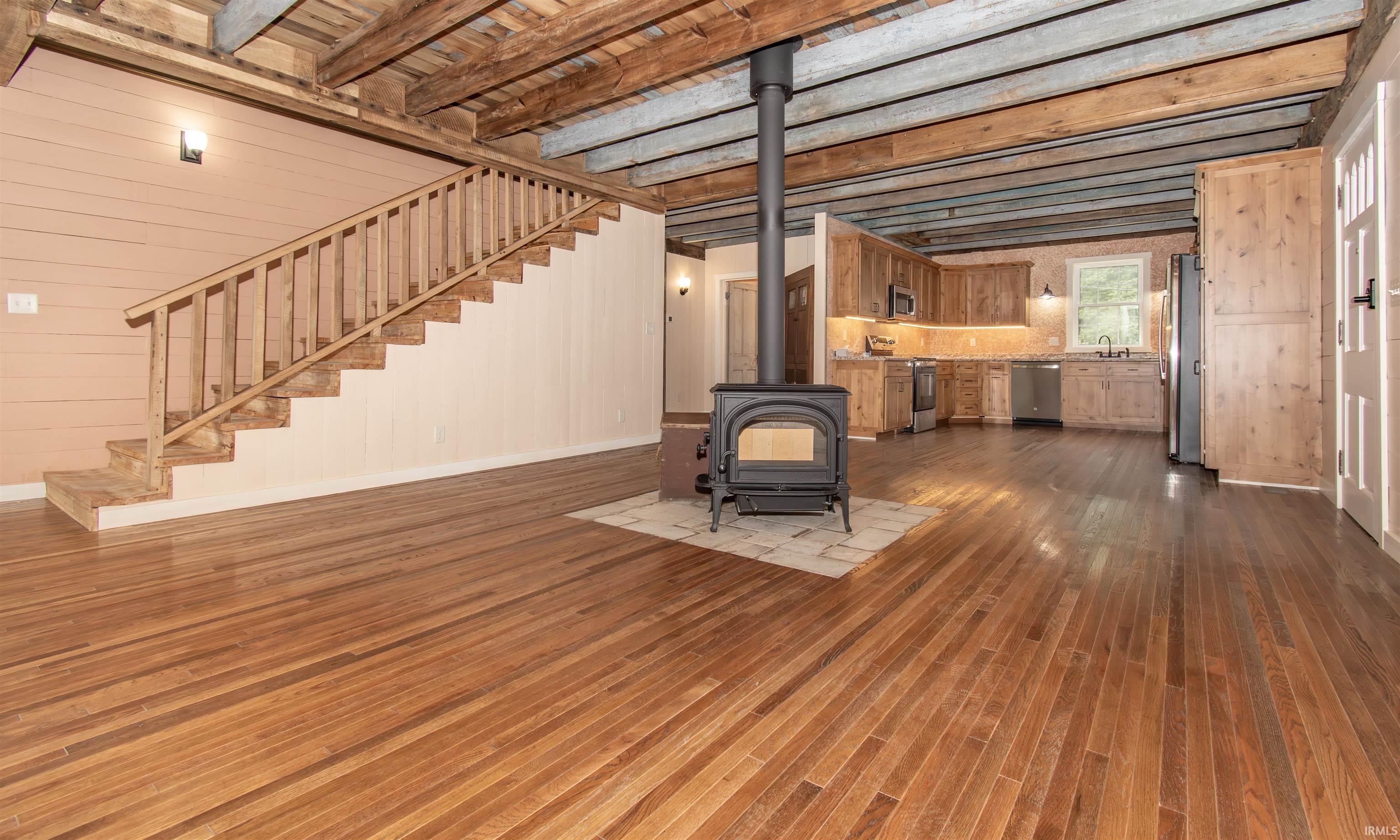 Open-concept living area featuring rich hardwood flooring throughout
