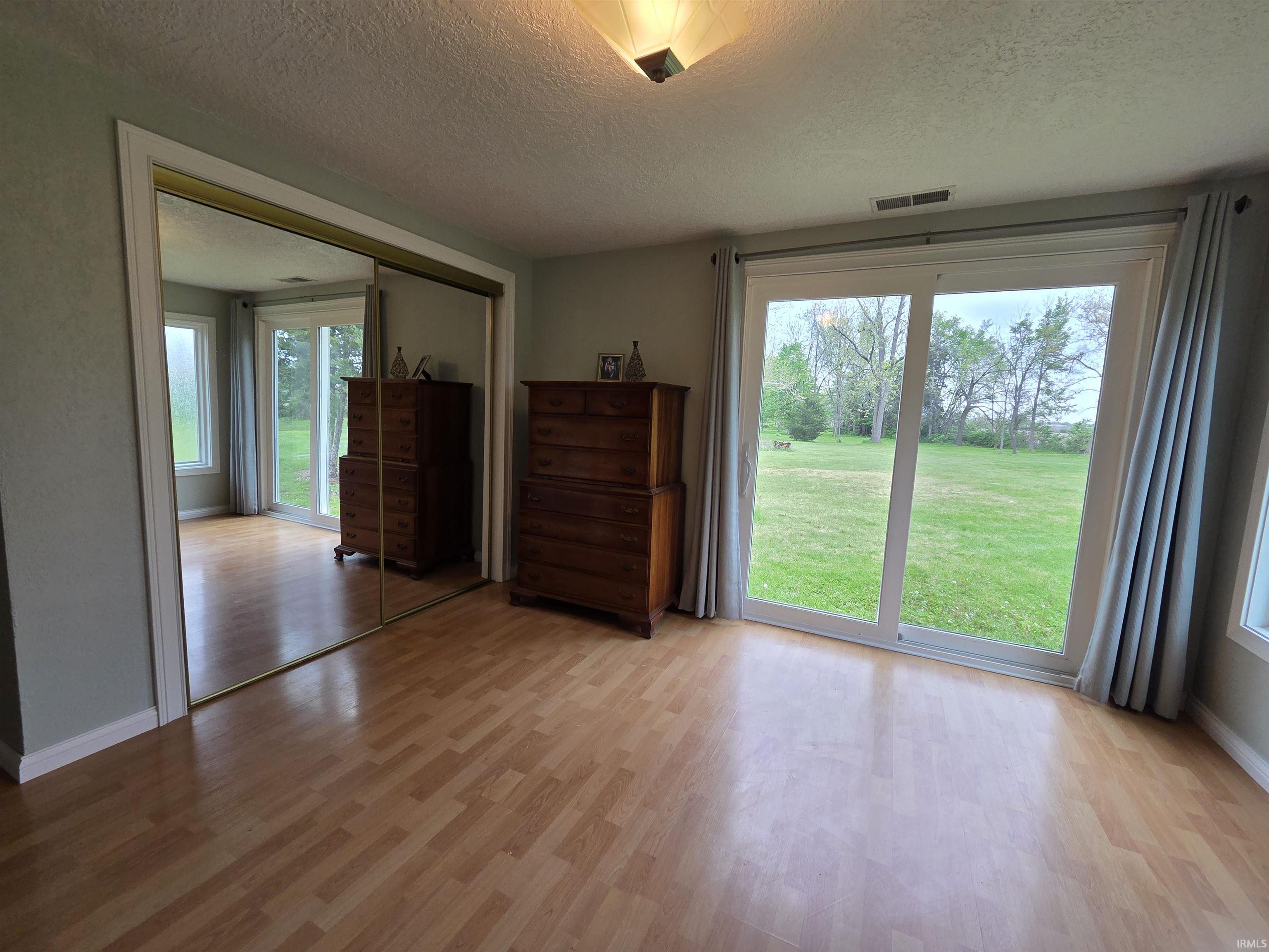 Room featuring expansive sliding glass doors providing direct outdoor access