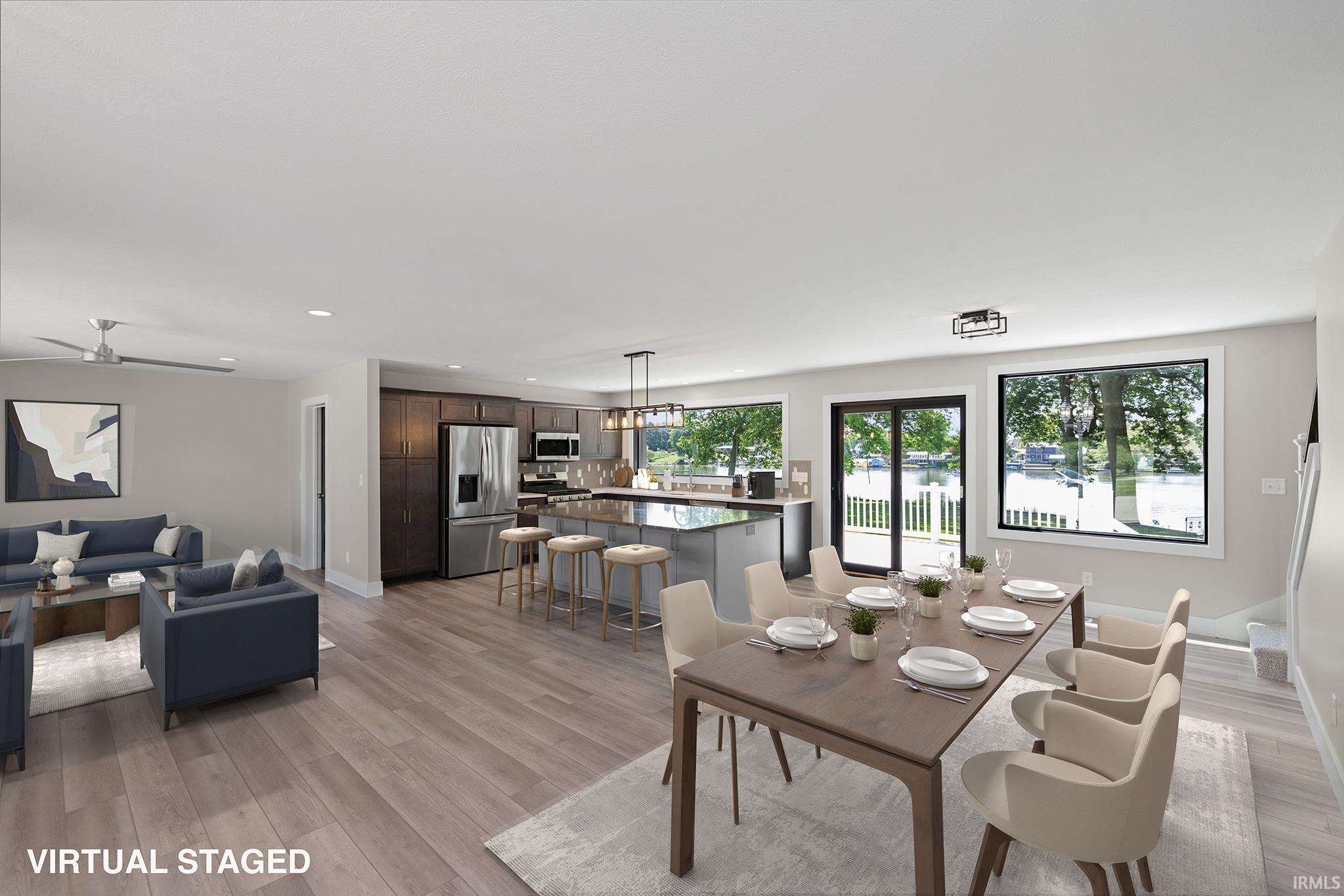 Spacious open-concept interior featuring light wood-finish flooring throughout