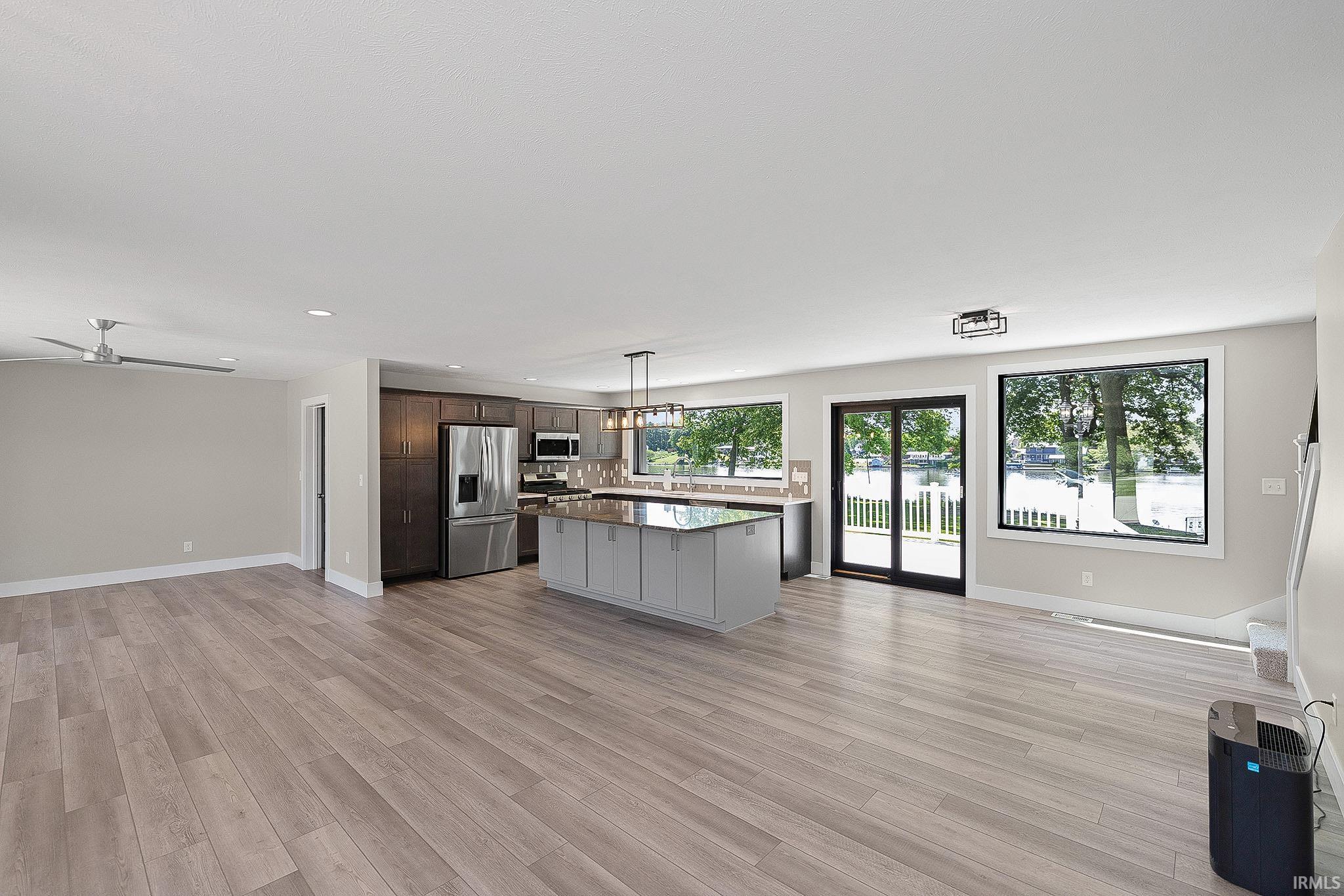 Open-concept interior featuring wood-finish flooring, recessed lighting, and a modern ceiling fan