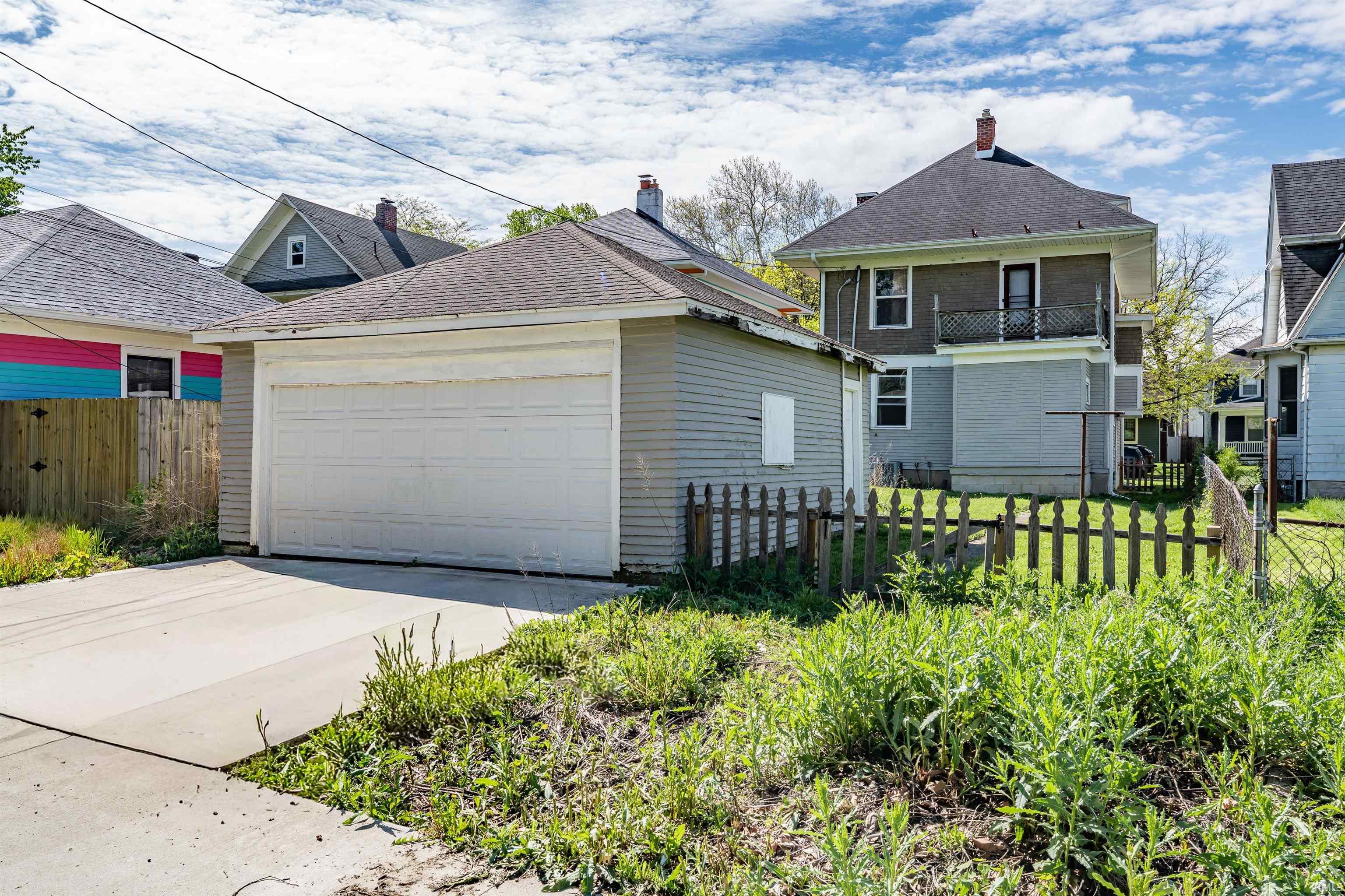 Detached two-car garage with a concrete driveway