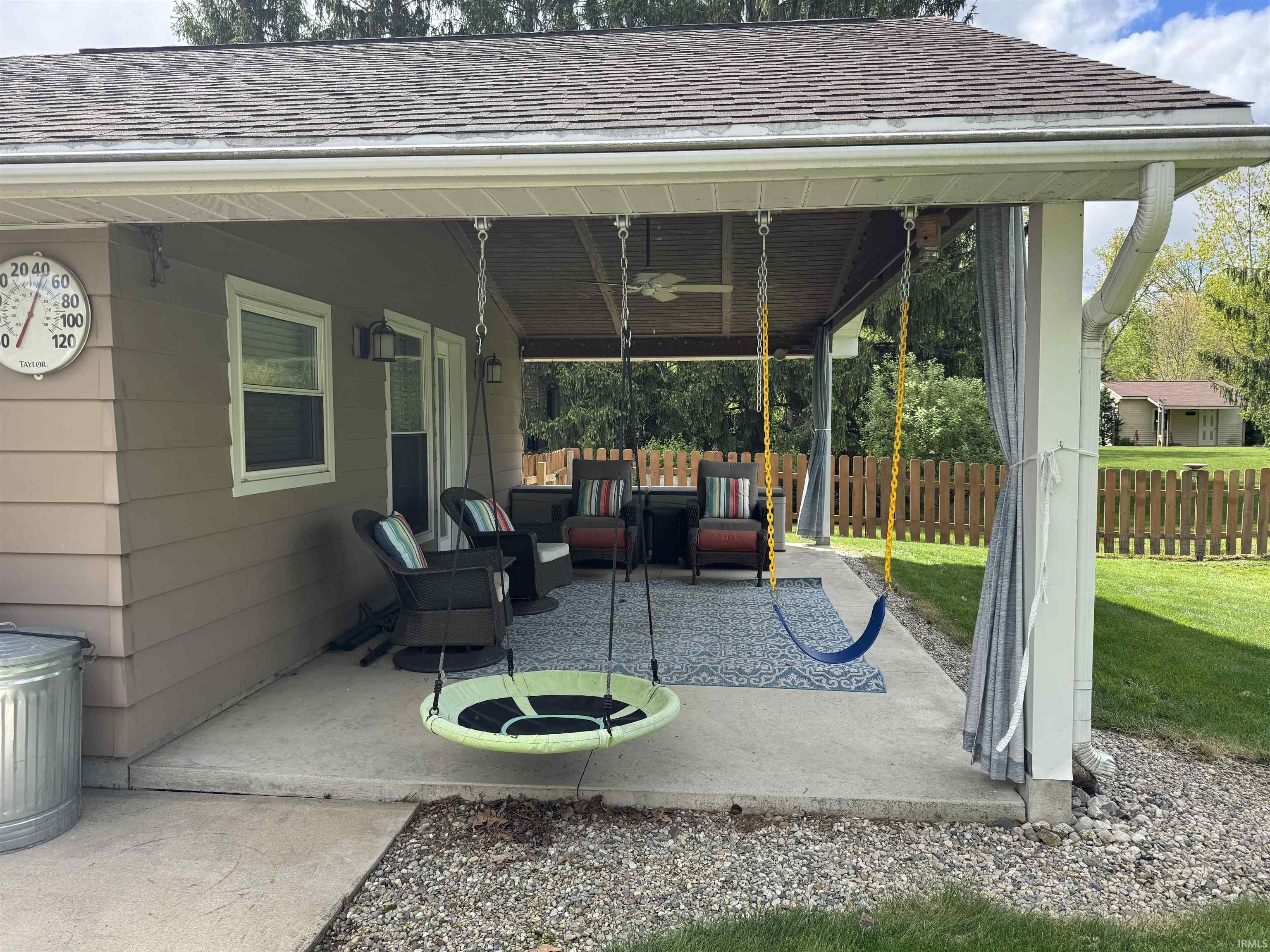 Covered patio featuring a concrete slab, exterior sconce lighting, and a white gutter system