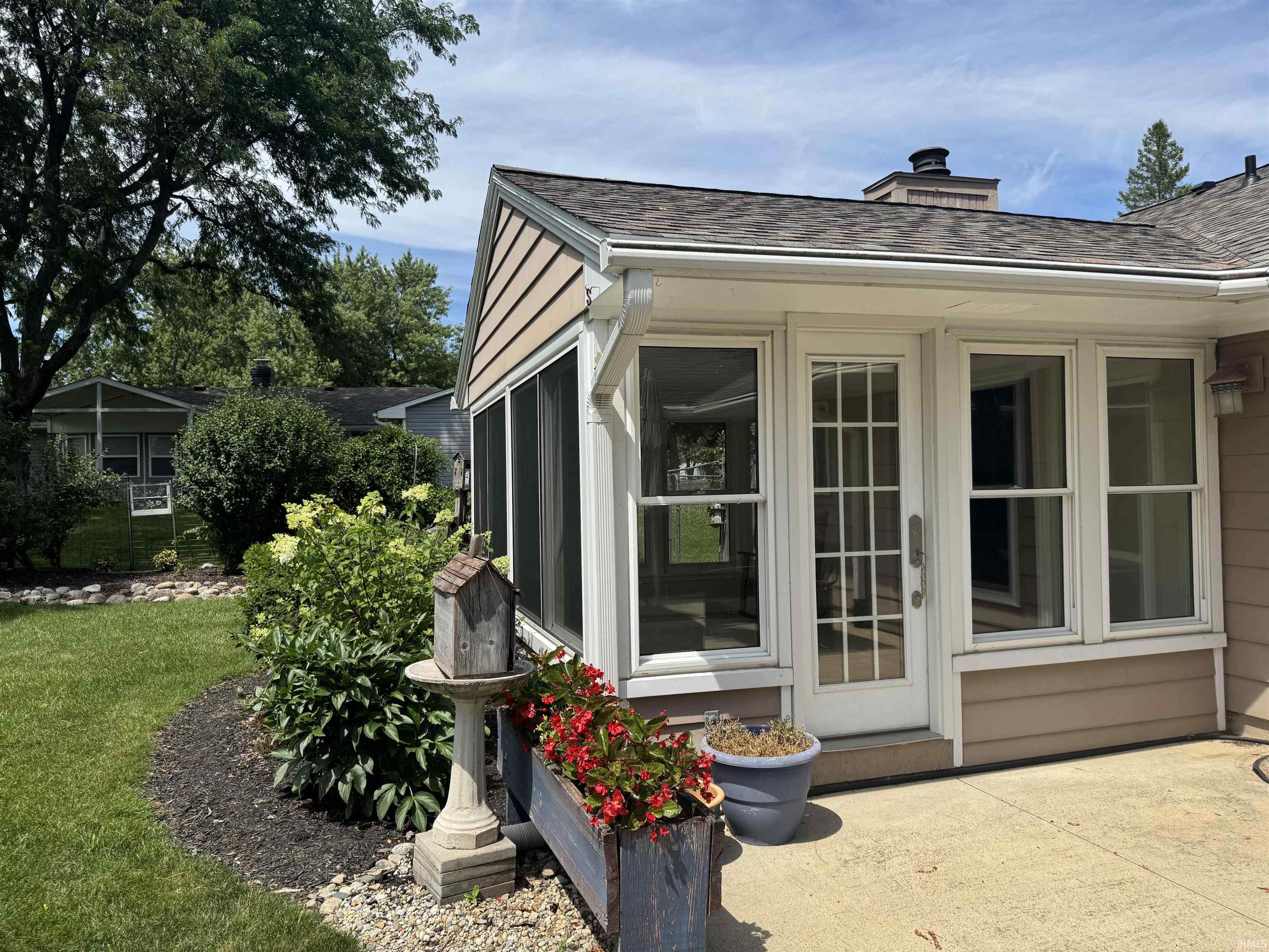Sunroom addition featuring a glass-paned door and multiple windows