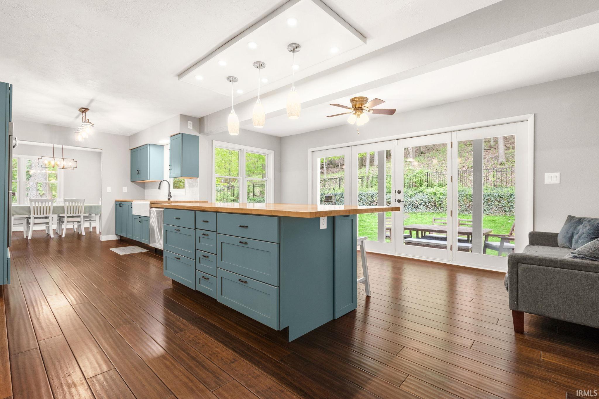 Expansive open-concept space featuring rich wood-finish flooring