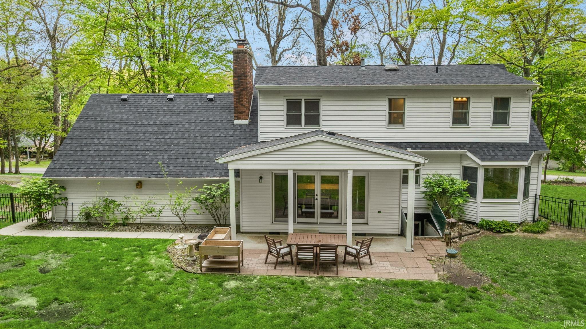 Rear exterior with white siding and dark shingle roofing