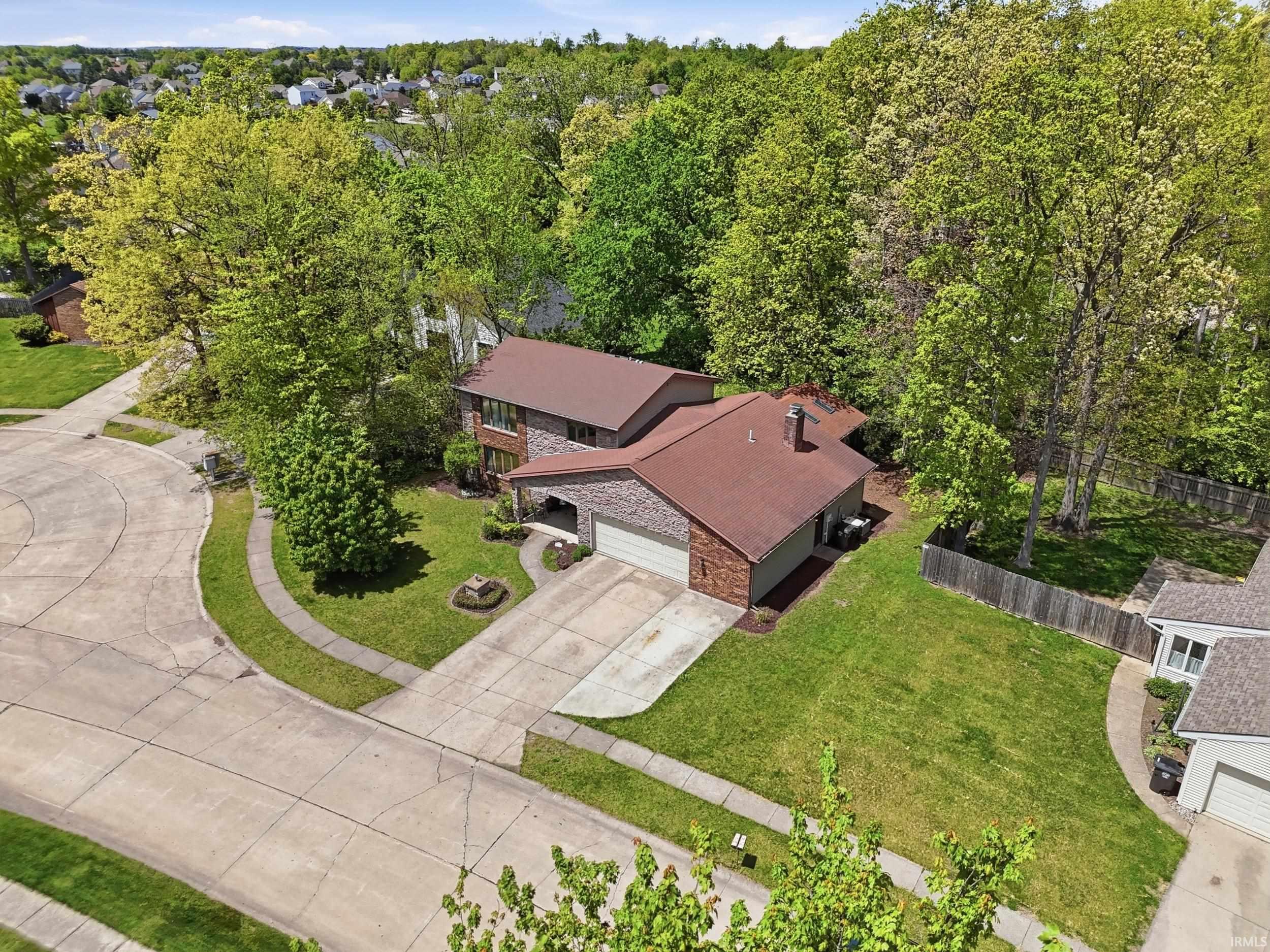 Brick-clad residence featuring an attached two-car garage