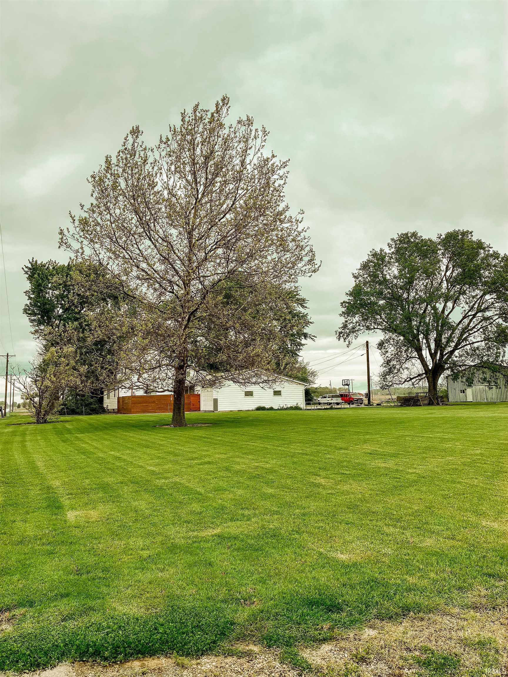 Expansive green lawn with mature trees