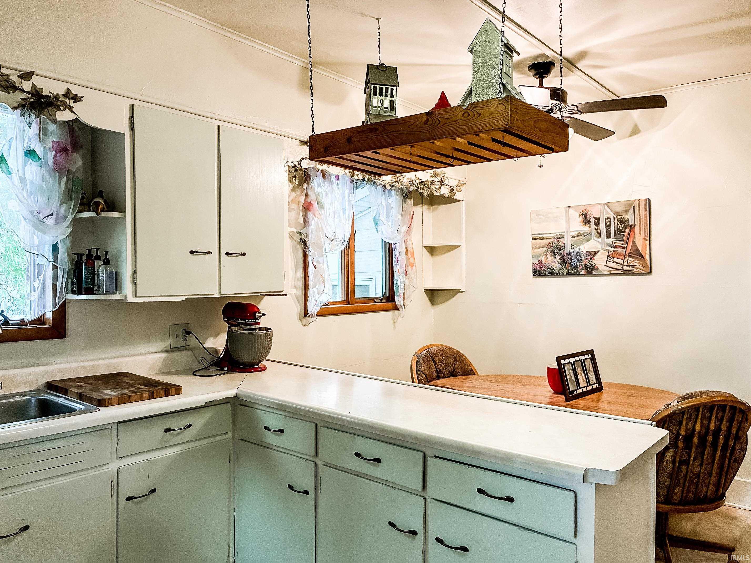 Kitchen featuring white cabinetry and light-colored countertops