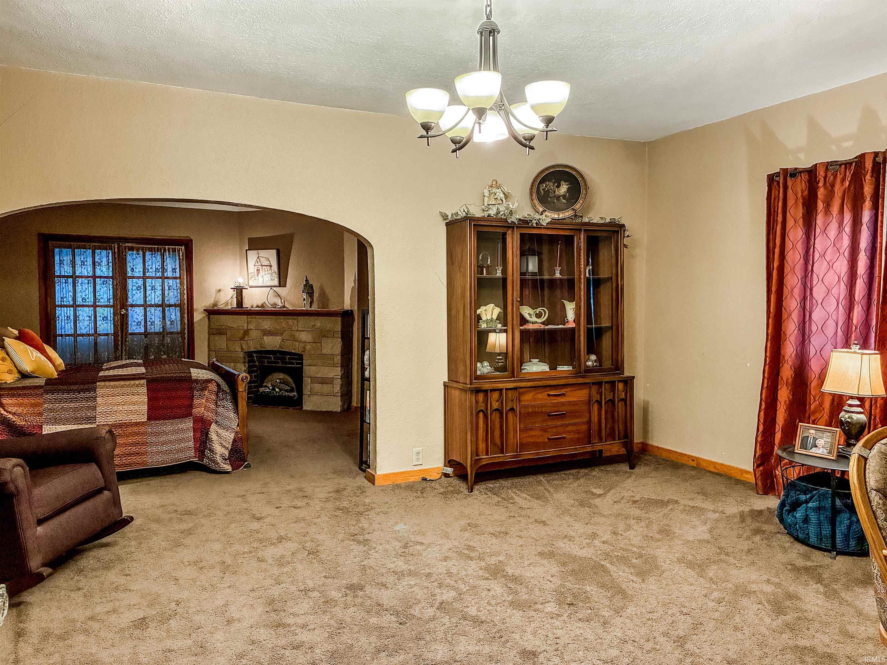 Main living area featuring a neutral carpet and walls