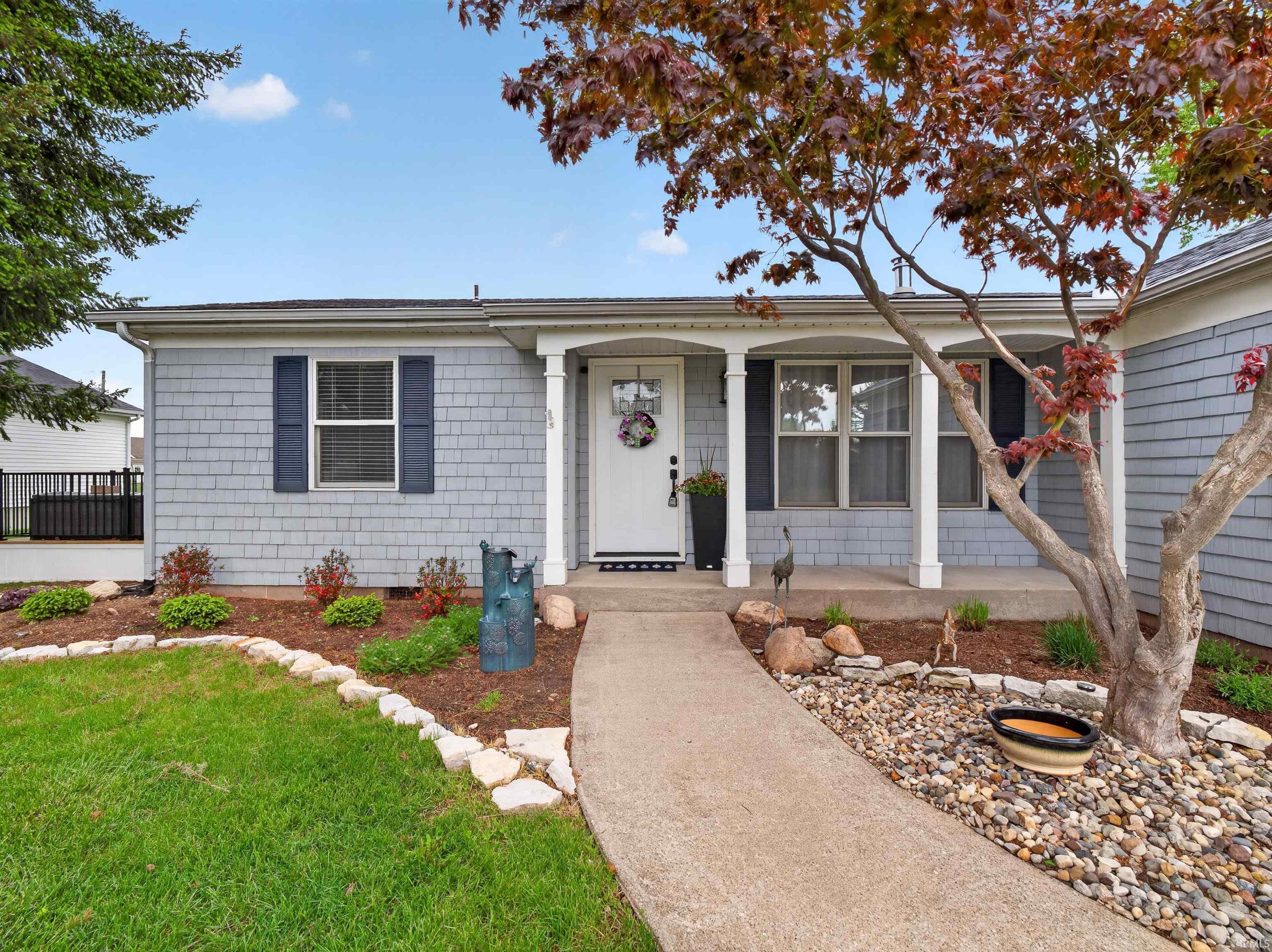 Front exterior with light gray shake siding and a covered entry