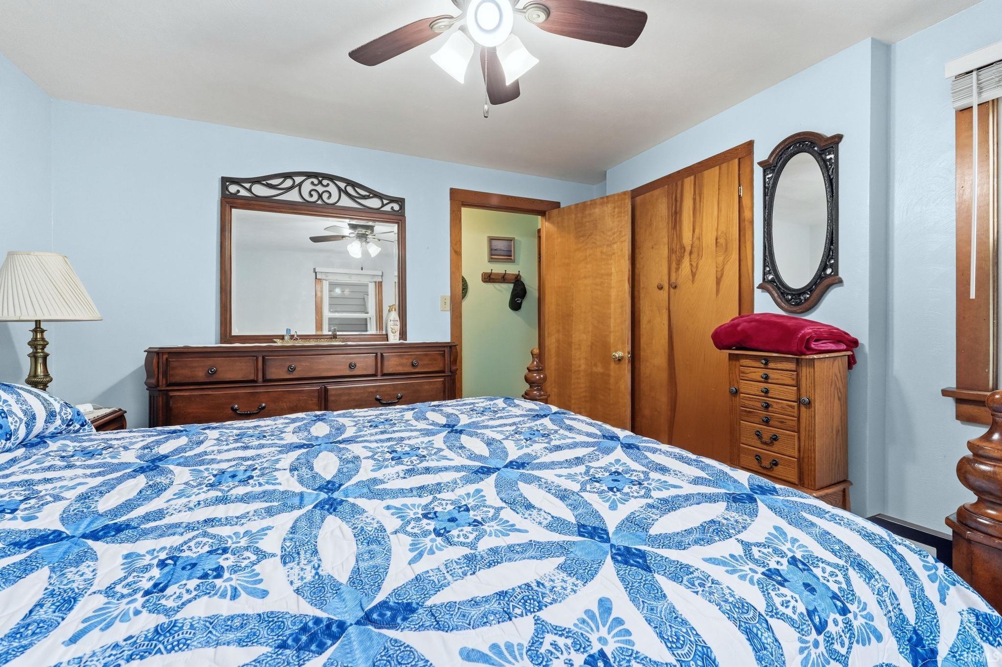 Light blue wall paint and a ceiling fan with light fixture