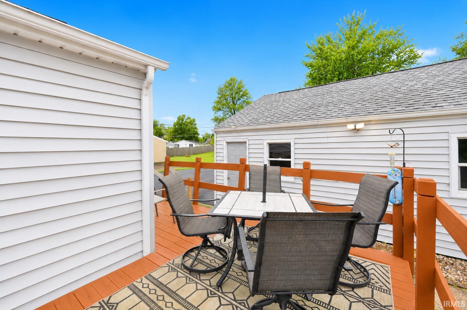 Spacious outdoor deck with wood-finish flooring and a surrounding wood railing