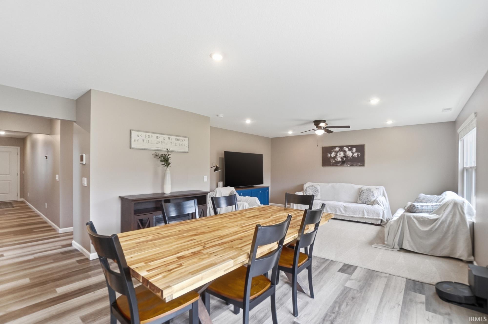 Open-concept living space featuring wood-finish flooring, recessed lighting, and a ceiling fan