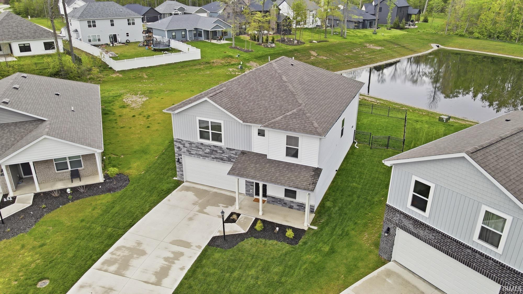 Two-story home featuring a covered front porch, an attached two-car garage, and a concrete driveway
