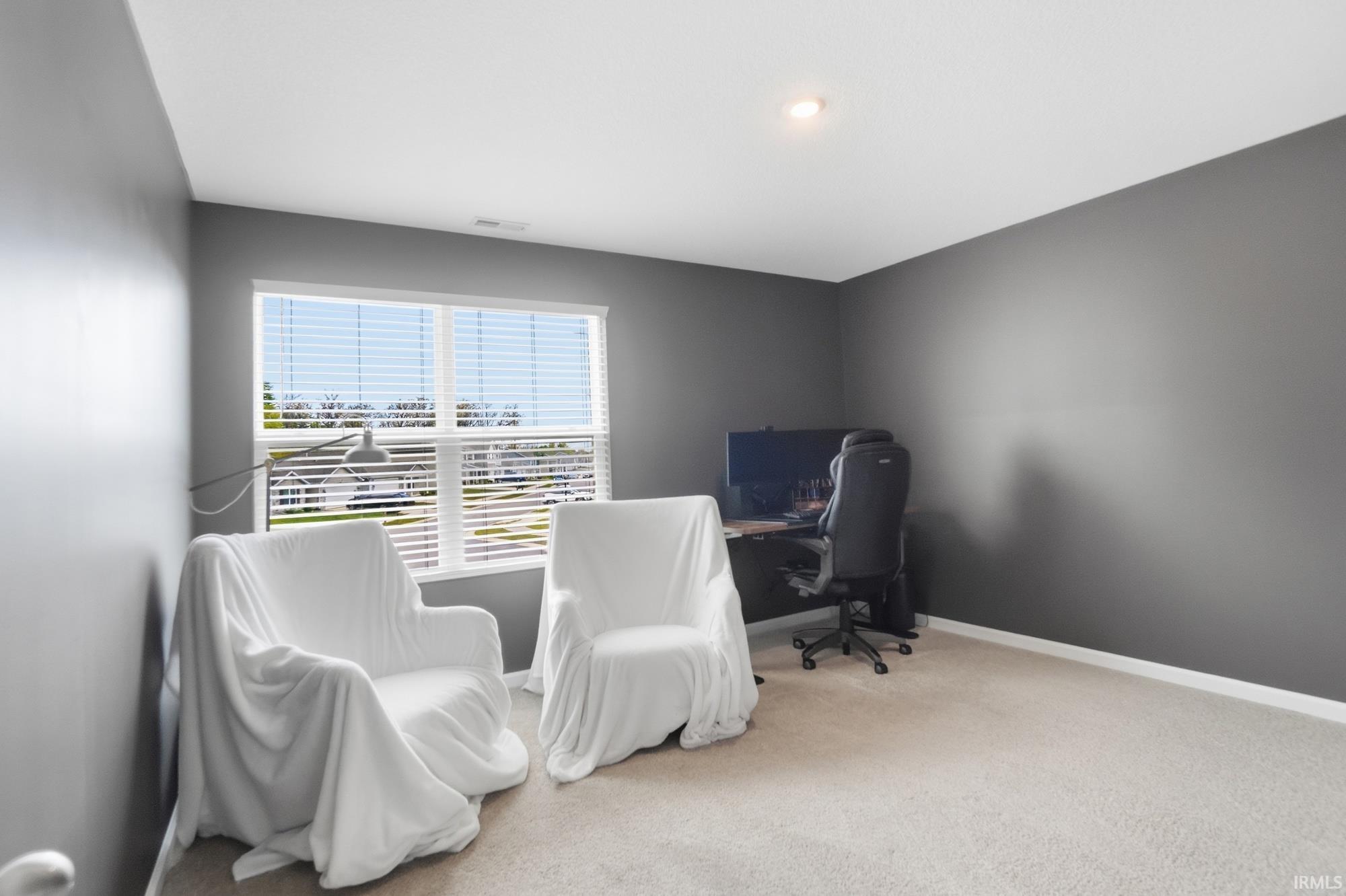 Bright room with neutral carpet flooring and white baseboards