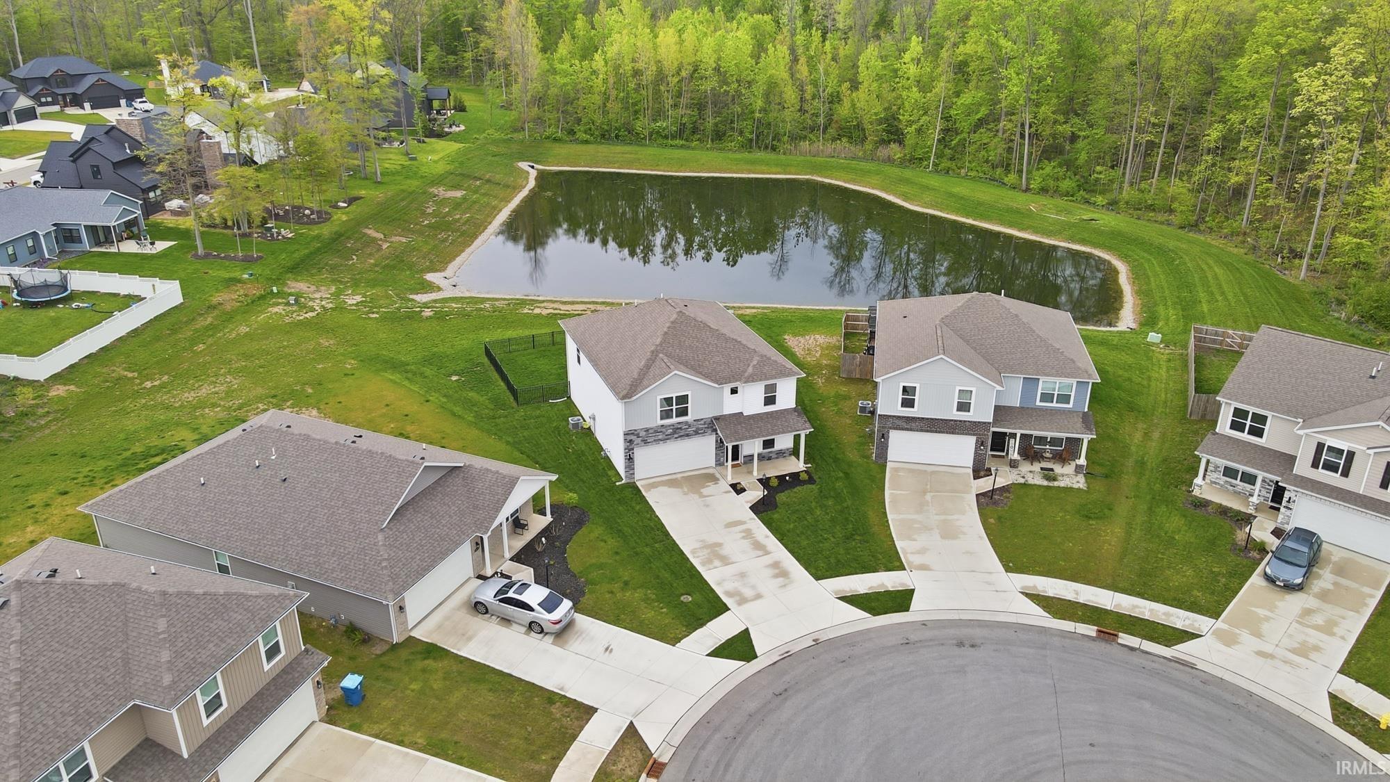 Cul-de-sac properties featuring mature trees and a serene pond