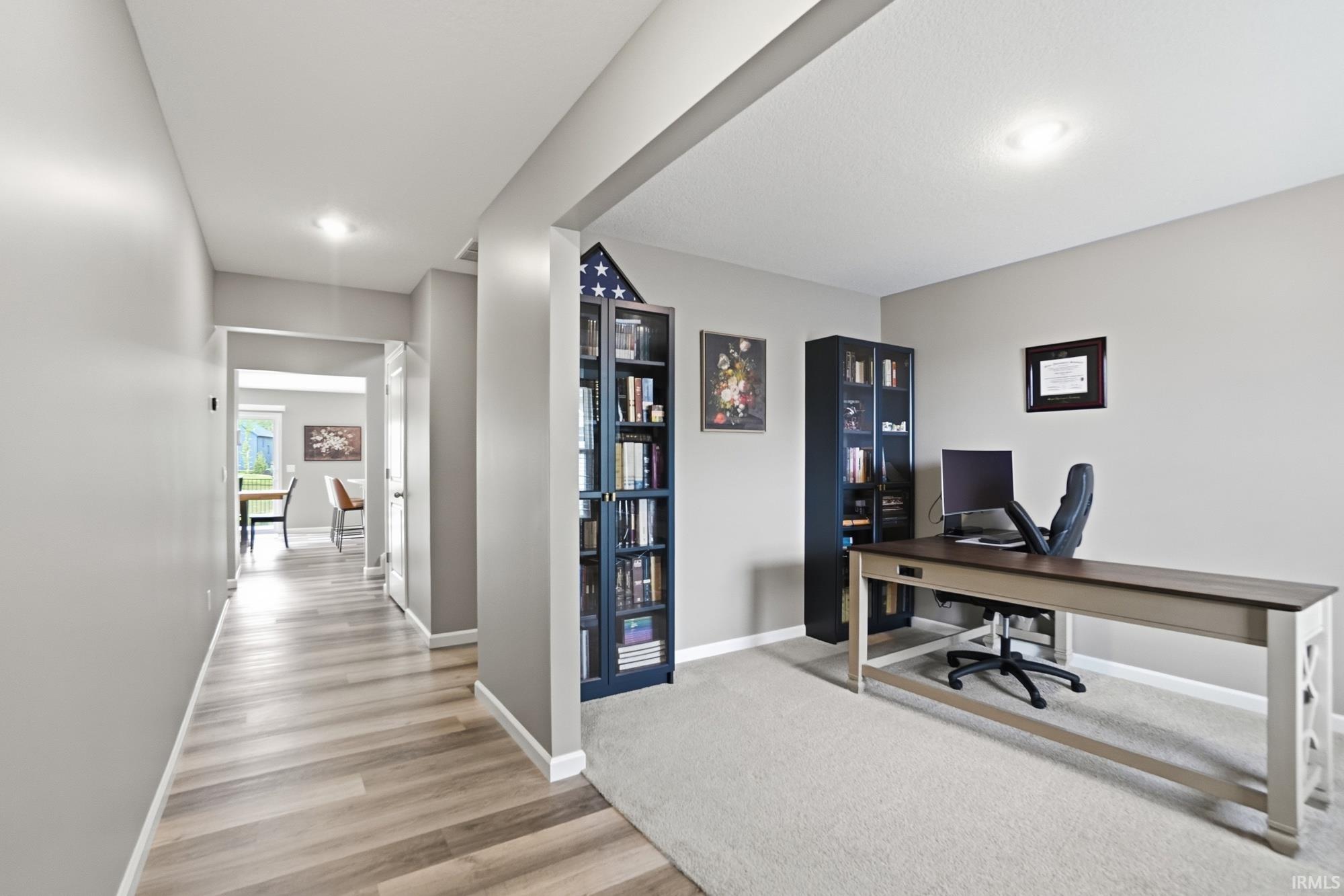 Dedicated office space featuring plush carpeting, recessed lighting, and a neutral color palette