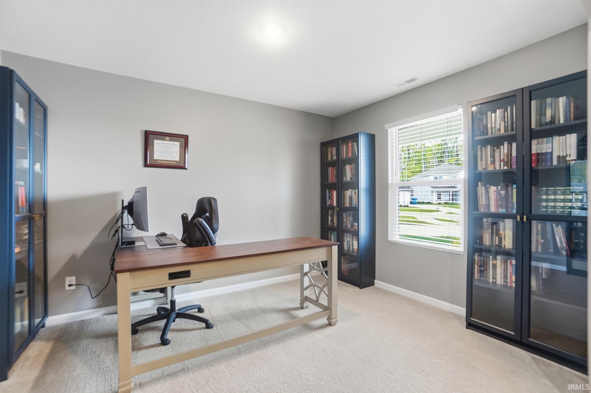 Carpeted room featuring light gray walls, a single window with blinds, and recessed lighting