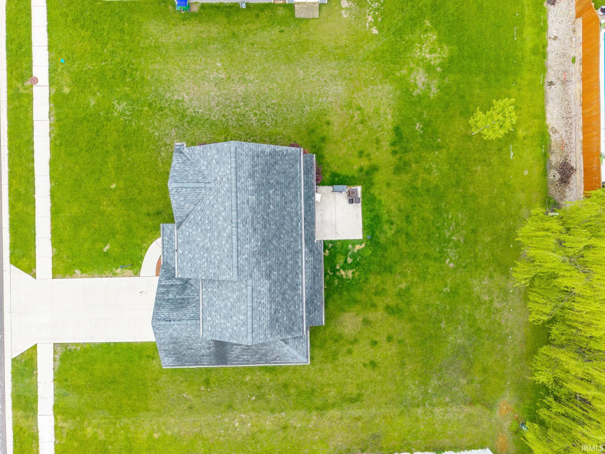 Aerial perspective showcasing a single-family residence with a gray shingle roof
