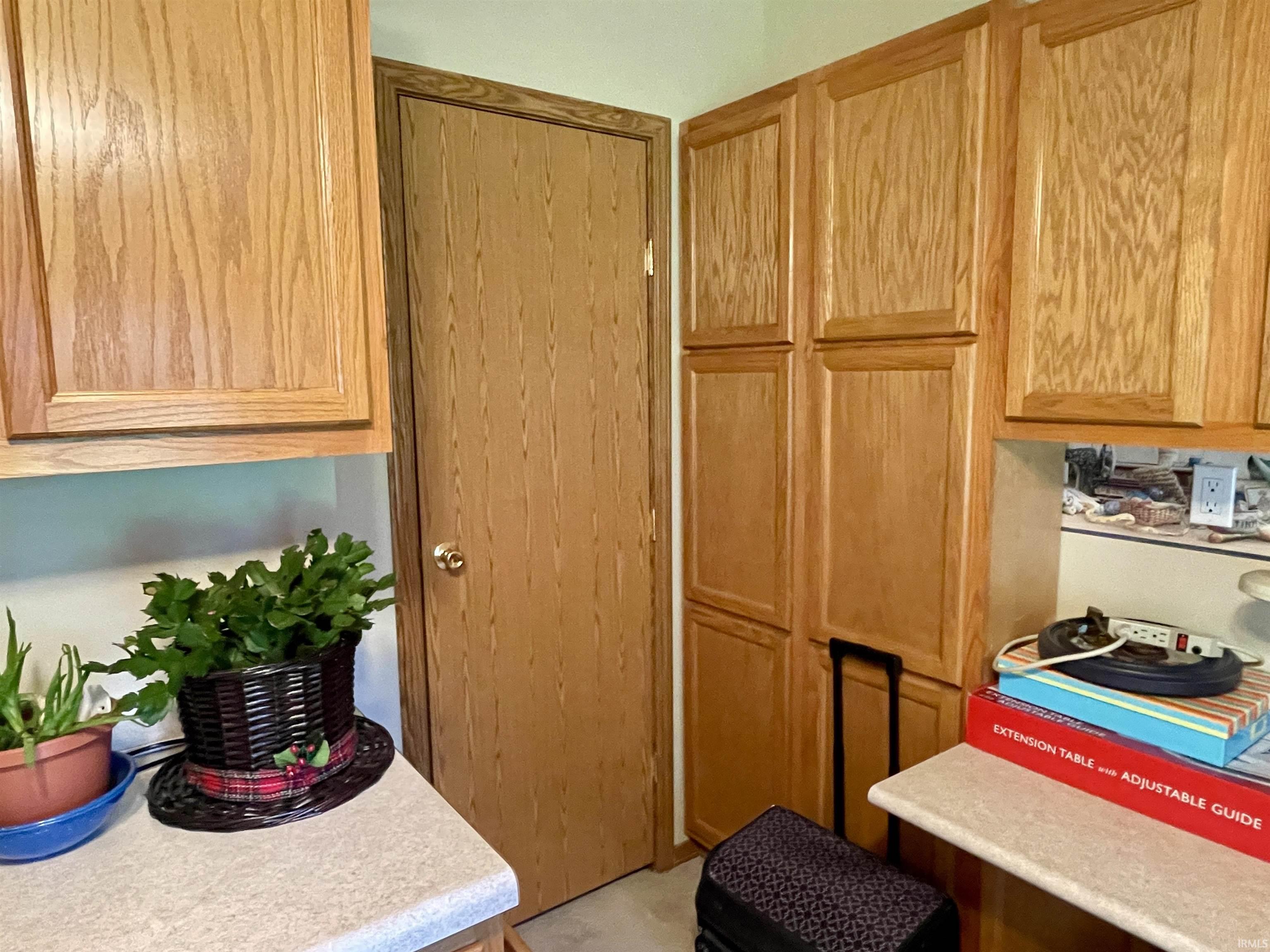 Oak cabinetry with a light wood finish and corresponding door