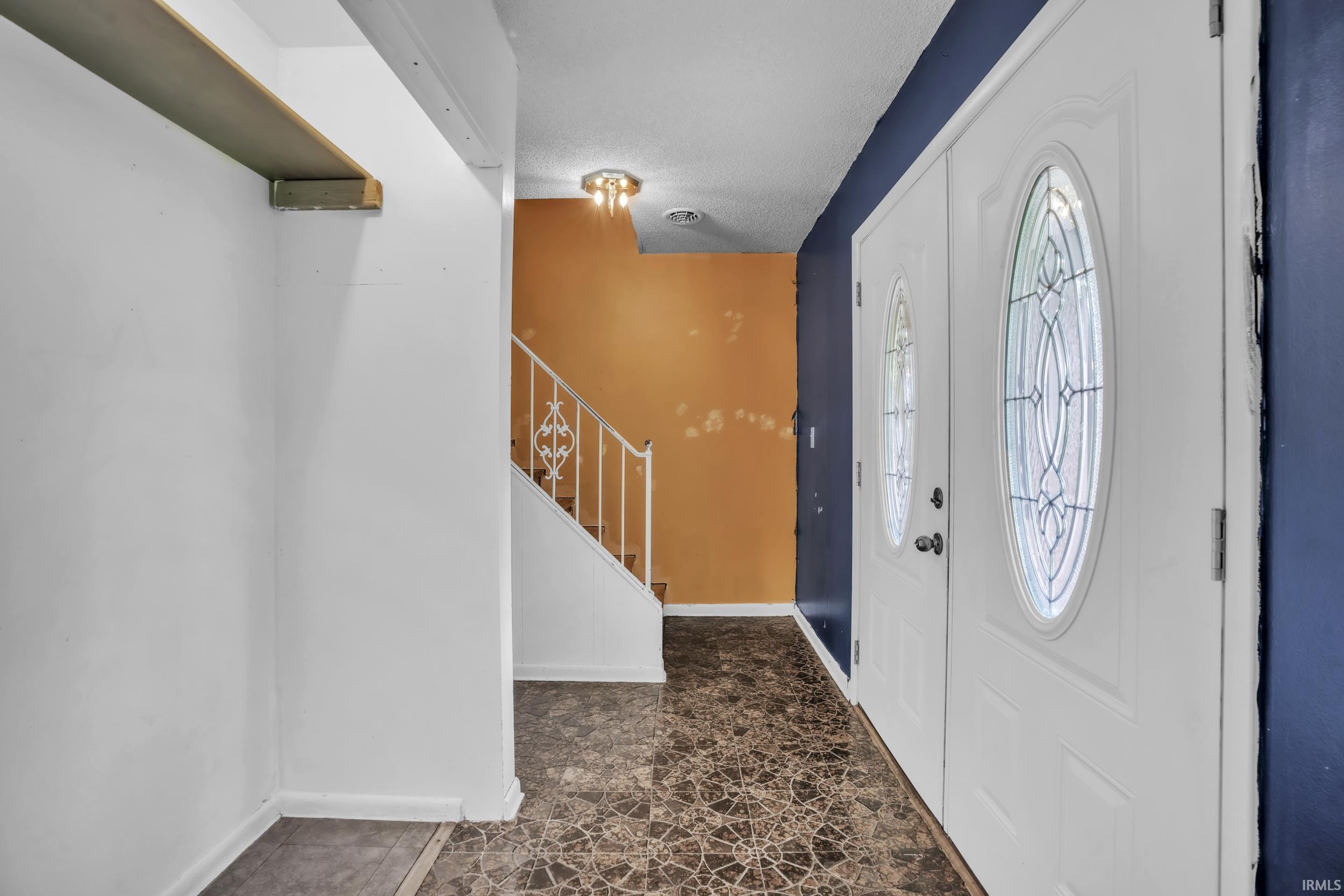 Double entry doors featuring oval-shaped leaded glass inserts