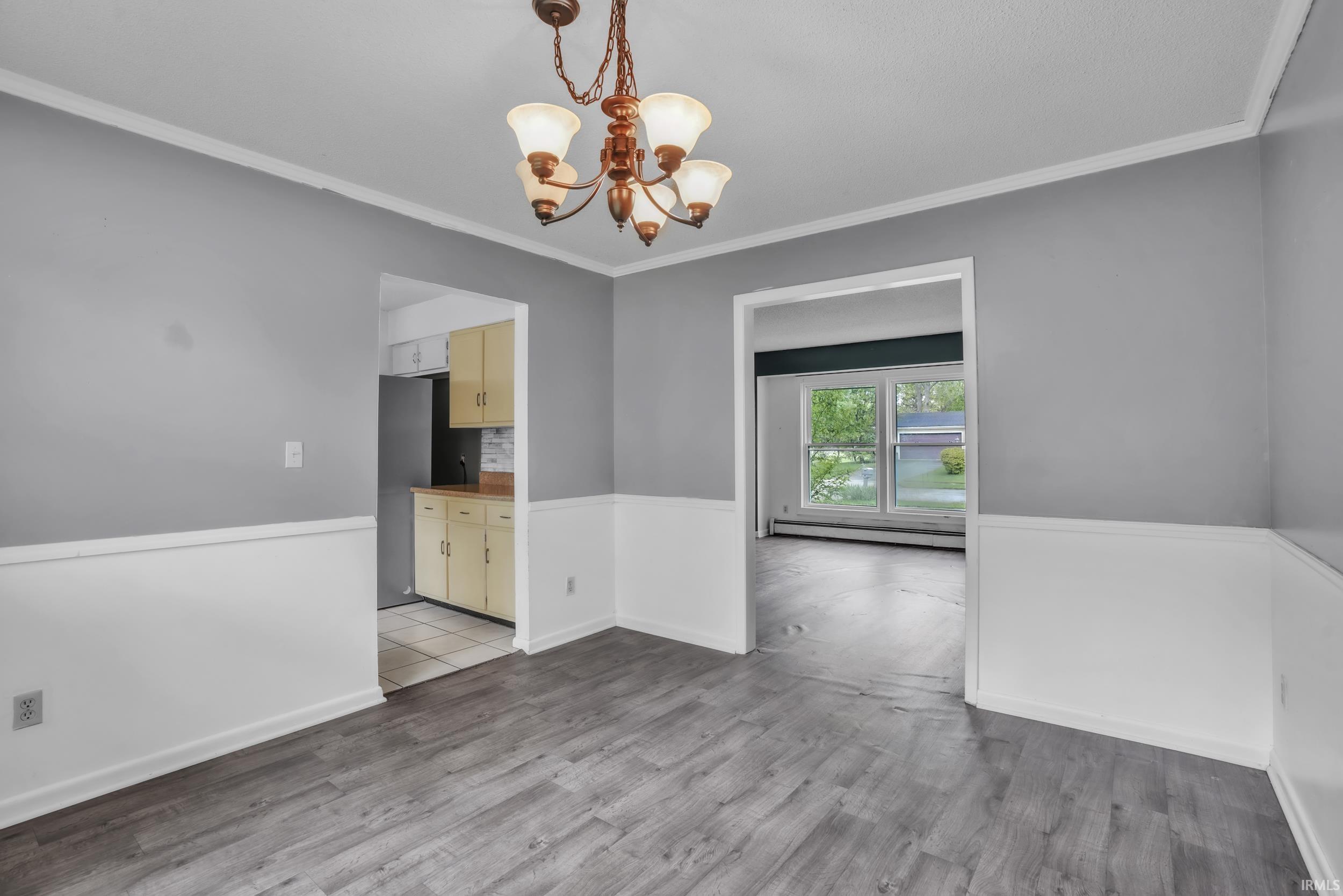 Wood-finish flooring with two-tone wall treatment and crown molding