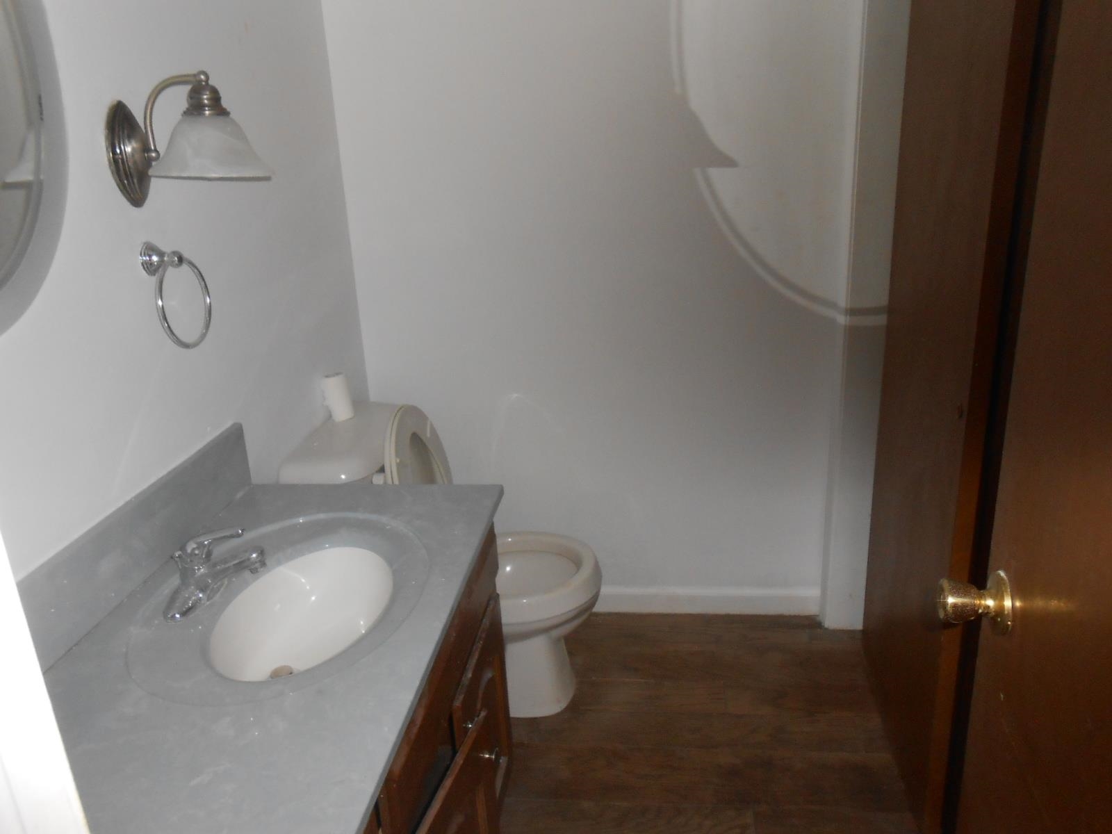 Vanity with an integrated white sink, gray countertop, and chrome faucet