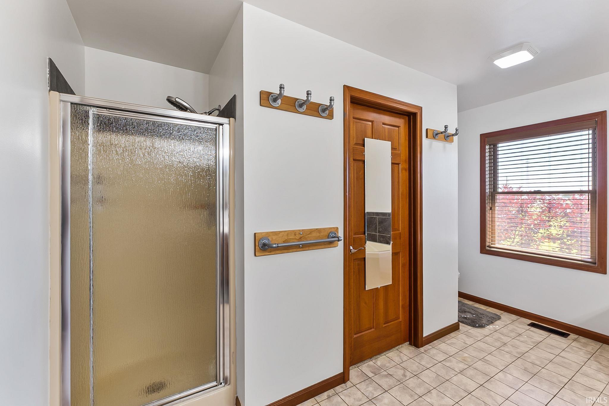 Walk-in shower with frosted glass enclosure