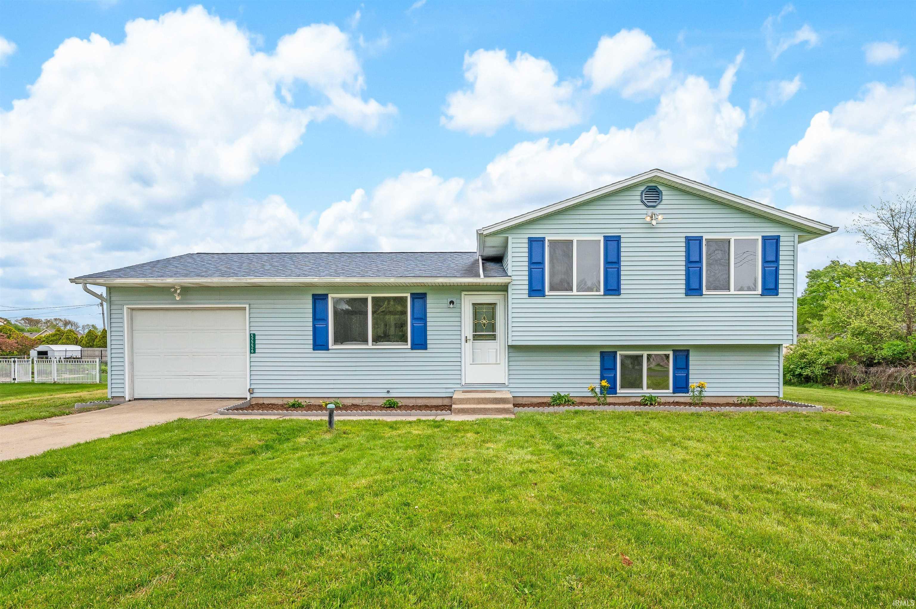 Light blue siding exterior featuring a split-level design