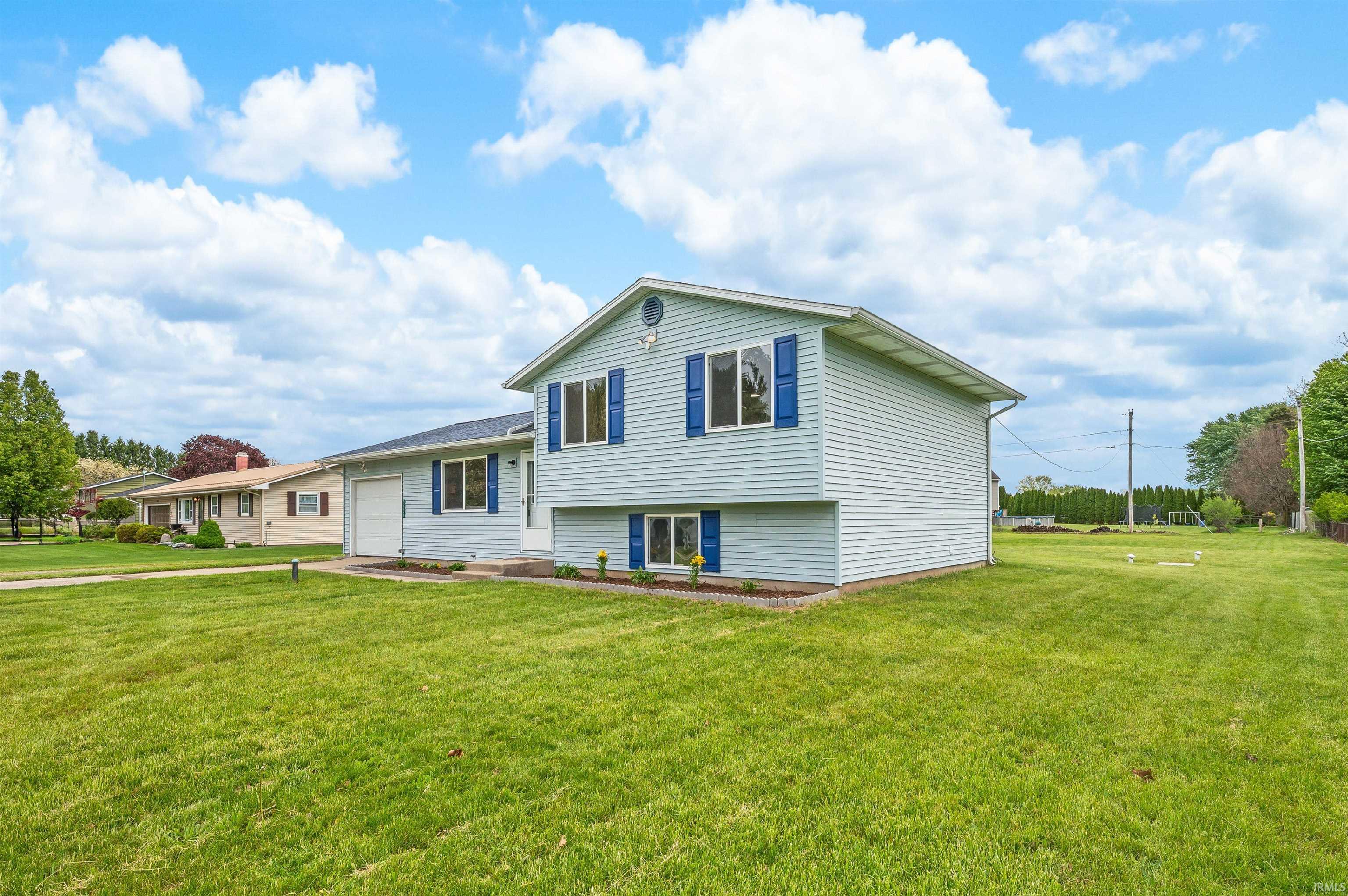 Light blue vinyl siding exterior with contrasting blue shutters