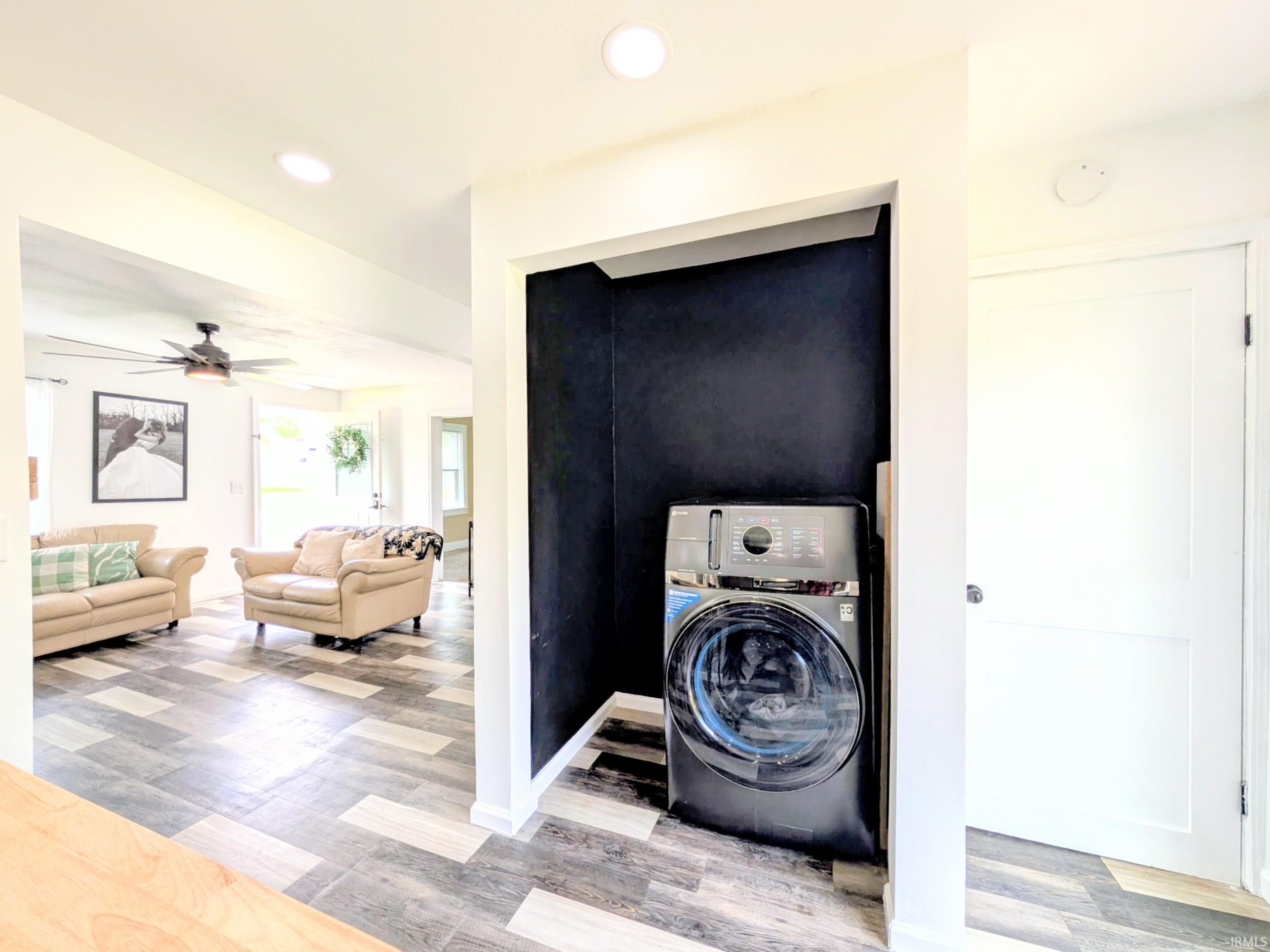 Laundry nook featuring a dark accent wall