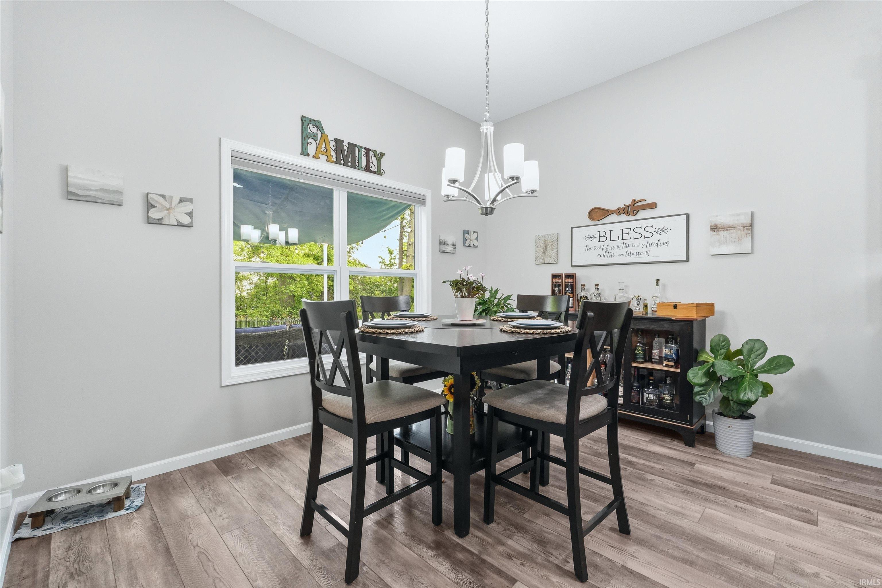 Dining area featuring wood-finish flooring and light gray painted walls