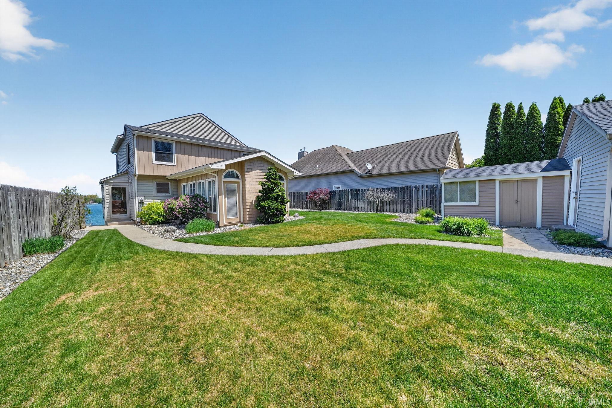 Expansive green lawn with a curving concrete pathway