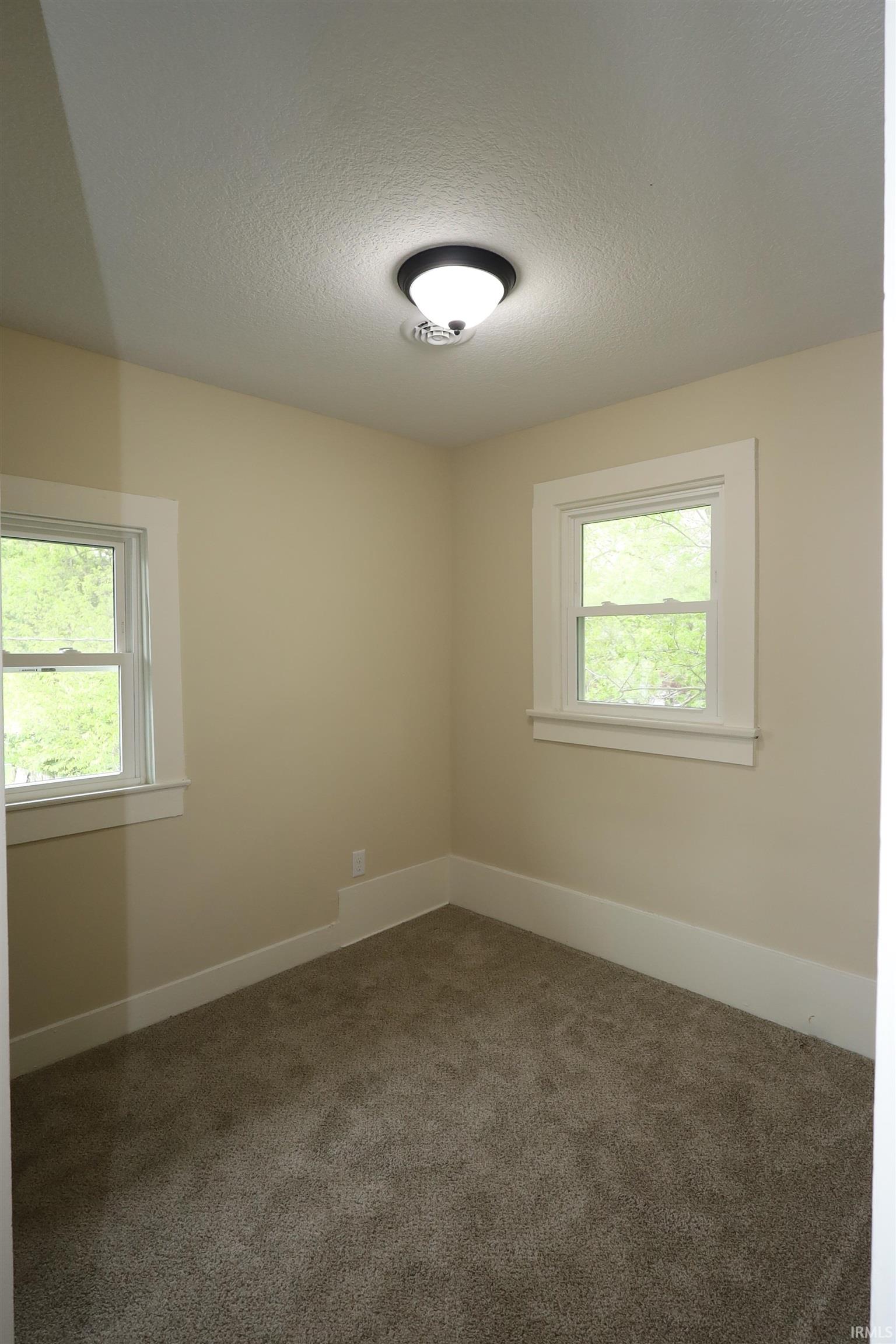 Neutral-toned walls complement plush carpeting