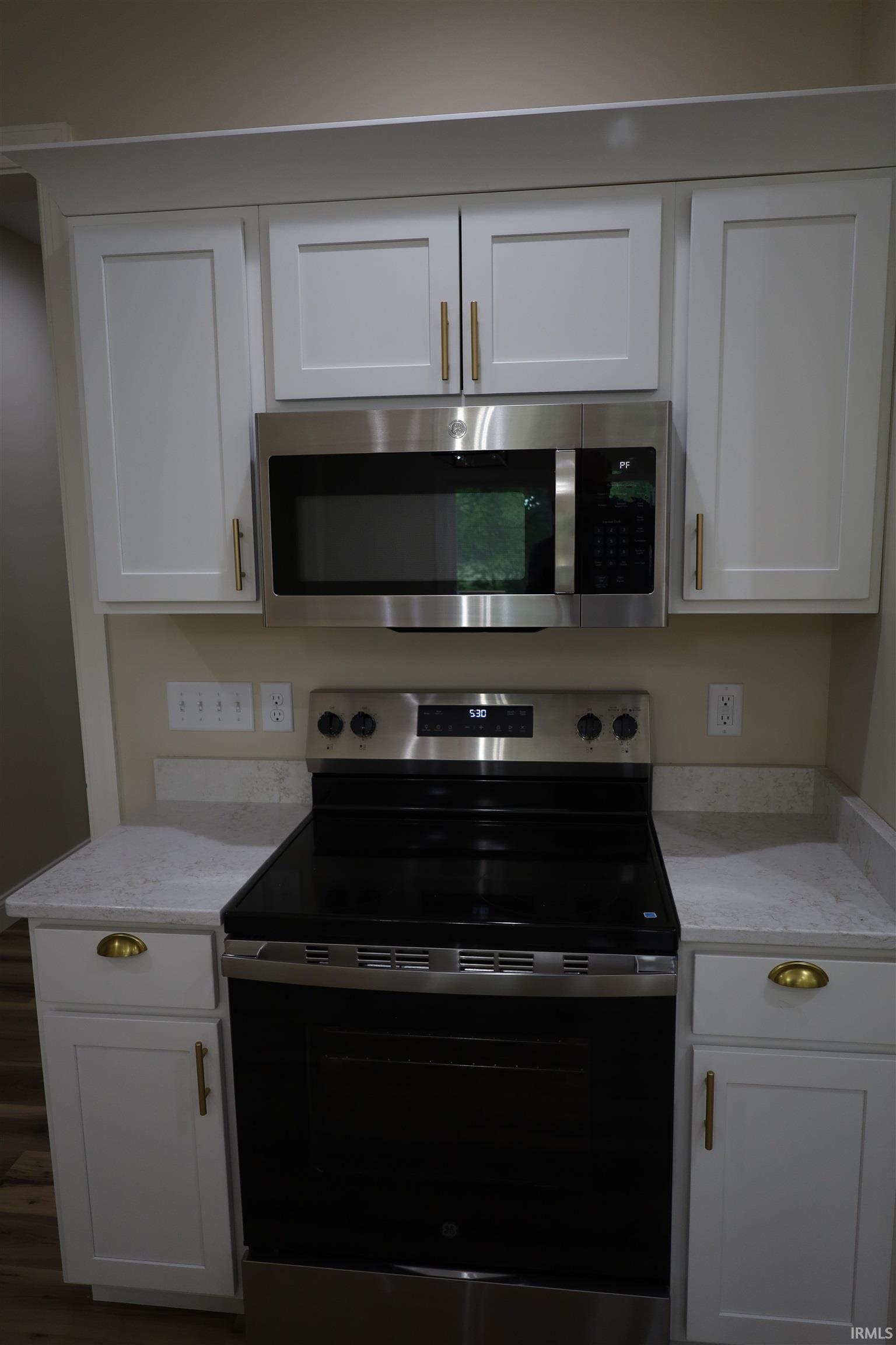 Stainless steel electric range with coordinating over-the-range microwave