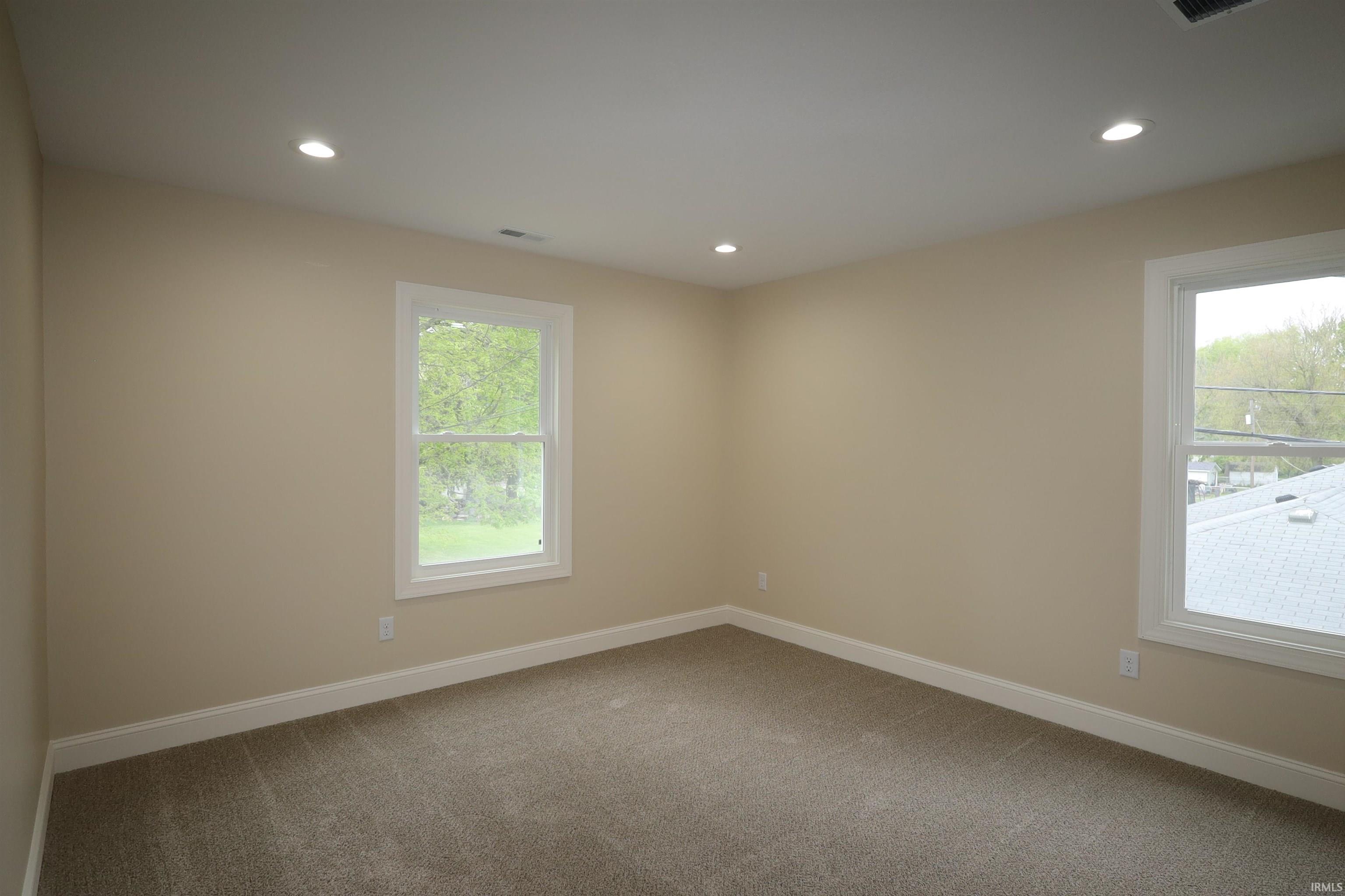 Neutral tone painted walls and trim featuring recessed ceiling lighting