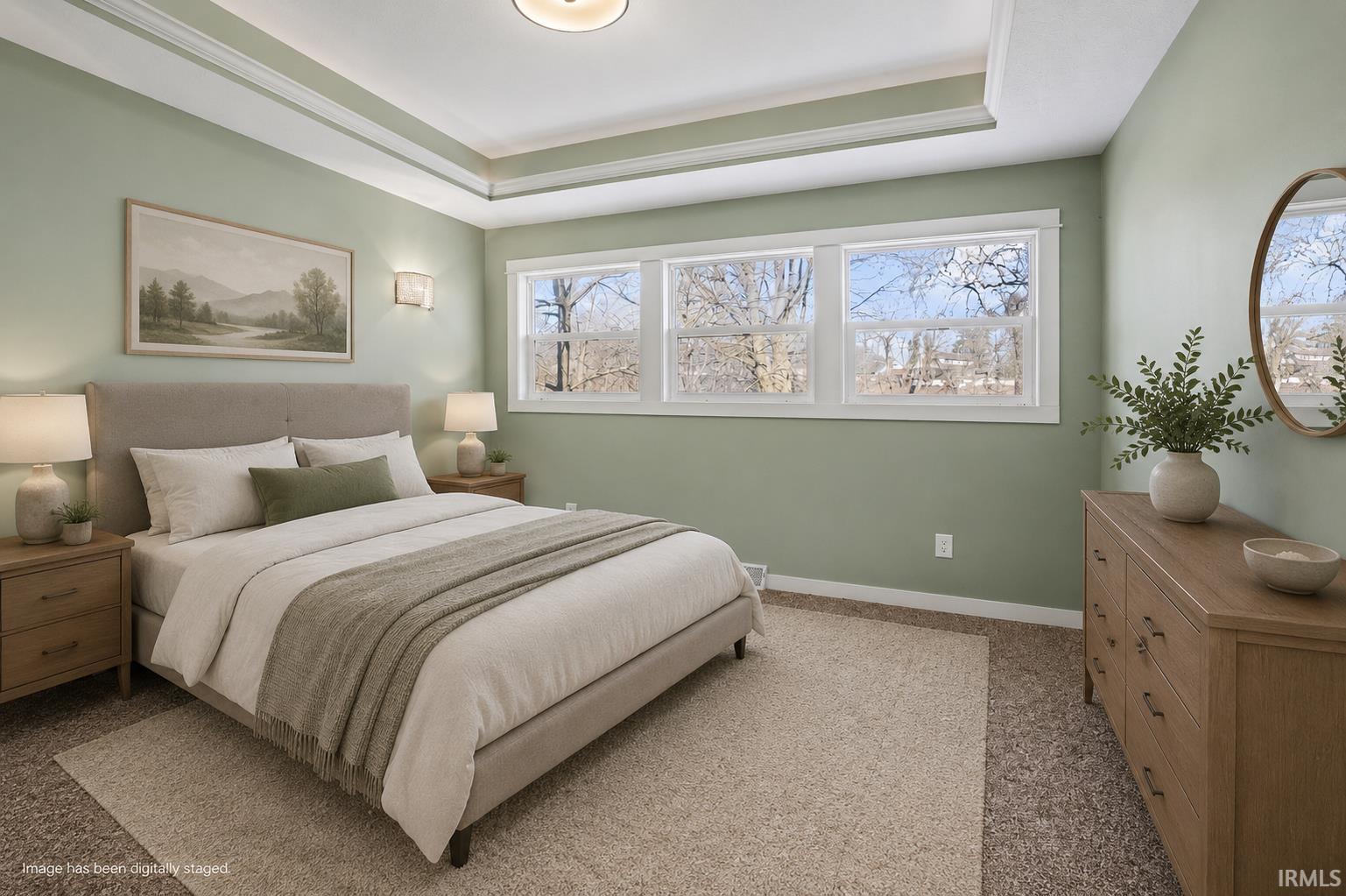 Recessed tray ceiling with crown molding, wide baseboards, and window trim create architectural interest